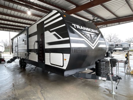 &lt;p class=&quot;MsoNormal&quot;&gt;&lt;span style=&quot;font-size: 12.0pt; line-height: 107%; font-family: &#39;Arial&#39;,sans-serif;&quot;&gt;Grand Design has done it again with another stunning travel trailer! The Transcend 321BH packs in tons of features that will make your travel simple and your rest relaxing!&lt;/span&gt;&lt;/p&gt;
&lt;p class=&quot;MsoNormal&quot;&gt;&lt;span style=&quot;font-size: 12.0pt; line-height: 107%; font-family: &#39;Arial&#39;,sans-serif;&quot;&gt;Starting outdoors, you will find conveniences like the detachable power cord, black tank flush, electric awning, and pass through storage. All of these combines to make your trip easy and no-hassle.&lt;/span&gt;&lt;/p&gt;
&lt;p class=&quot;MsoNormal&quot;&gt;&lt;span style=&quot;font-size: 12.0pt; line-height: 107%; font-family: &#39;Arial&#39;,sans-serif;&quot;&gt;Once you step inside though, you will find your home away from home! There is theater seating that will greet you and provide a spot to sit while catching a flick on the flat screen LED HDTV. Right below the TV you will find an AM/FM/CD player!&lt;/span&gt;&lt;/p&gt;
&lt;p class=&quot;MsoNormal&quot;&gt;&lt;span style=&quot;font-size: 12.0pt; line-height: 107%; font-family: &#39;Arial&#39;,sans-serif;&quot;&gt;Next, you will probably want to saunter over to the L-shaped kitchen because this trailer provides all the tools necessary to prepare whatever you are hungry for, whether it is a little snack or something scrumptious for all on board! There is a refrigerator, a 3-burner stove top, an oven, a microwave, a sink with sink covers, and tons of storage all those must-haves. Right across from the kitchen is the booth dinette where you will want to plop down and relax with a plate of food!&lt;/span&gt;&lt;/p&gt;
&lt;p class=&quot;MsoNormal&quot;&gt;&lt;span style=&quot;font-size: 12.0pt; line-height: 107%; font-family: &#39;Arial&#39;,sans-serif;&quot;&gt;Down the hall is the bathroom which does not skimp on features! You will have a toilet, a shower with shower curtain, a sink, an extended counter top and a mirrored medicine cabinet.&lt;/span&gt;&lt;/p&gt;
&lt;p class=&quot;MsoNormal&quot;&gt;&lt;span style=&quot;font-size: 12.0pt; line-height: 107%; font-family: &#39;Arial&#39;,sans-serif;&quot;&gt;The master bedroom is at the front of the trailer and it includes a queen-sized bed with decorative bedspread and surrounding storage! You will be sure to catch lots of ZZZs!&lt;/span&gt;&lt;/p&gt;
&lt;p class=&quot;MsoNormal&quot;&gt;&lt;span style=&quot;font-size: 12.0pt; line-height: 107%; font-family: &#39;Arial&#39;,sans-serif;&quot;&gt;At the back of the Transcend is the spacious bunkhouse! It features four bunks, two 32&amp;rdquo; bunks on the left and a 28&amp;rdquo; top bunk with 30&amp;rdquo; bottom bunk along the rear wall. There are also storage drawers and a half bath inside the bunkhouse.The half bathroom comes equipped with a foot flush toilet and sink with storage below.&lt;/span&gt;&lt;/p&gt;
&lt;p class=&quot;MsoNormal&quot;&gt;&lt;span style=&quot;font-size: 12.0pt; line-height: 107%; font-family: &#39;Arial&#39;,sans-serif;&quot;&gt;Call or stop by today to see the excellent quality of Grand Design for yourself and to check out this new fantastic travel trailer!&lt;/span&gt;&lt;/p&gt;