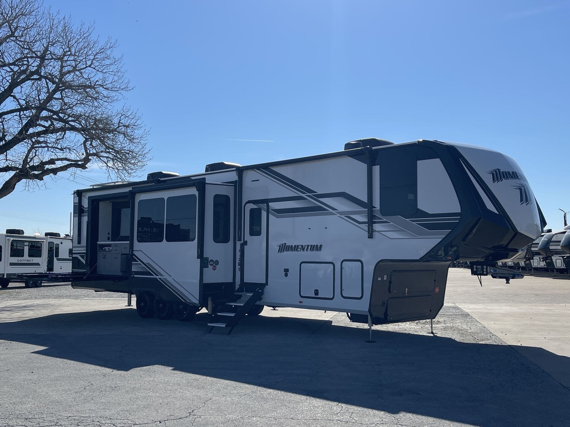 2026 Grand Design Momentum 399M - New Toy Hauler For Sale by McClain's RV Superstore in Corinth, Texas features TV, Toilet, Day/Night Shades, Smoke Detector, Air Conditioning