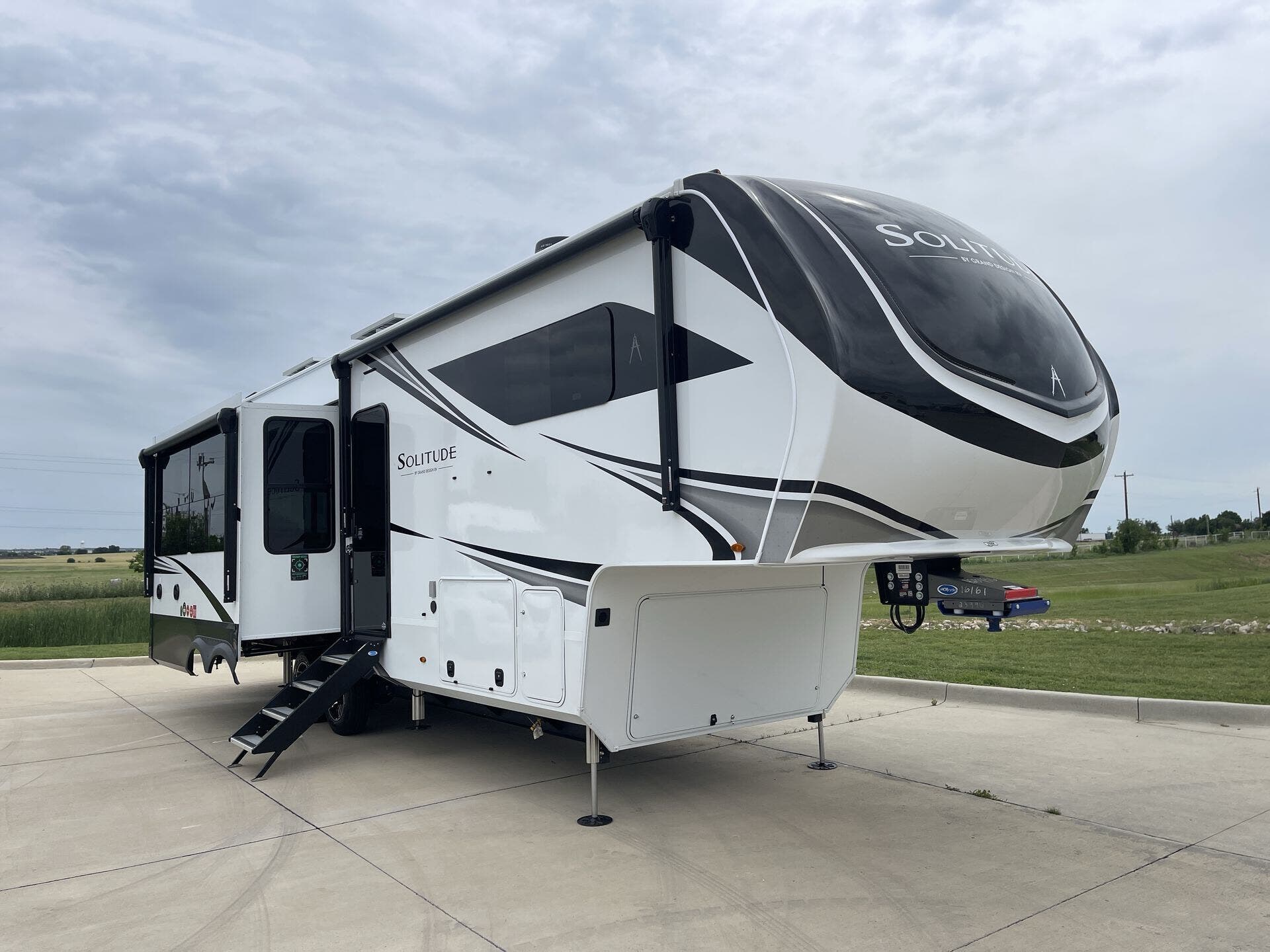 2026 Grand Design Solitude 310GK - New Fifth Wheel For Sale by McClain's Longhorn RV in Sanger, Texas features Theater Seating, Dinette, Slideout, Power Awning, Overhead Cabinetry