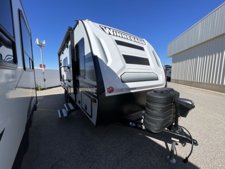 &lt;p&gt;&lt;strong&gt;Experience Compact Comfort with the 2024 Winnebago Micro Minnie 1800BH Travel Trailer&lt;/strong&gt;&lt;/p&gt;
&lt;p&gt;Get ready to explore the open road with the 2024 Winnebago Micro Minnie 1800BH, a compact and lightweight travel trailer that delivers big on comfort and versatility. Whether you&#39;re a seasoned RVer or new to the camping lifestyle, this Micro Minnie is designed to provide you with a comfortable and convenient travel experience.&lt;/p&gt;
&lt;p&gt;&lt;strong&gt;Compact and Lightweight:&lt;/strong&gt; The Micro Minnie 1800BH is built with convenience in mind. Its compact size and lightweight design make it easy to tow, allowing you to navigate winding roads and reach your favorite destinations with ease.&lt;/p&gt;
&lt;p&gt;&lt;strong&gt;Exterior Features:&lt;/strong&gt; This travel trailer boasts an exterior that&#39;s both functional and stylish. The electric awning provides shade and outdoor living space, while the exterior storage compartments offer ample room for your camping gear and essentials.&lt;/p&gt;
&lt;p&gt;&lt;strong&gt;Interior Comfort:&lt;/strong&gt; Step inside, and you&#39;ll discover a thoughtfully designed interior that maximizes space and comfort. The living area features a comfortable sofa, a dinette that easily converts into a bed, and large windows that flood the space with natural light.&lt;/p&gt;
&lt;p&gt;&lt;strong&gt;Efficient Kitchen:&lt;/strong&gt; The kitchen is fully equipped with modern appliances, including a stove, microwave, refrigerator, and ample storage for your kitchen supplies. Preparing delicious meals on the road has never been easier.&lt;/p&gt;
&lt;p&gt;&lt;strong&gt;Private Sleeping Space:&lt;/strong&gt; The Micro Minnie 1800BH provides a private sleeping area with bunk beds for the kids or guests, as well as a cozy queen-sized bed for you to enjoy a restful night&#39;s sleep after a day of adventure.&lt;/p&gt;
&lt;p&gt;&lt;strong&gt;Modern Amenities:&lt;/strong&gt; This travel trailer is equipped with modern amenities to enhance your camping experience. Stay comfortable year-round with efficient heating and air conditioning systems. Enjoy entertainment on the road with a flat-screen TV, sound system, and multimedia connections.&lt;/p&gt;
&lt;p&gt;&lt;strong&gt;Adventure Awaits:&lt;/strong&gt; The 2024 Winnebago Micro Minnie 1800BH is your gateway to outdoor adventures. Whether you&#39;re exploring national parks, camping by a serene lake, or simply hitting the road, this travel trailer offers the comforts of home wherever your journey takes you.&lt;/p&gt;