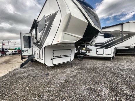 &lt;p&gt;When the outdoors is calling your name, and you are looking for a weekend thrill, choose this Momentum M-Class 381MS toy hauler fifth wheel by Grand Design. You will find plenty of space for a few off-road toys, as well, there is plenty of comfortable living space throughout.&lt;/p&gt;
&lt;p&gt;The garage features 15&#39; of space for an ATV or a few dirt bikes. There are also plenty of windows which allows for natural lighting. Once your gear is unloaded then easily set up the Happi-Jac rollover sofas for additional seating for family and friends. Above the sofas there is an optional top bunk. There is another overhead bed plus this area has been prepped for a washer and dryer so now you can keep up with your laundry instead of going home with dirty clothes. The garage is also TV prepped for your enjoyment. A half bathroom is also located off the garage. Here you will find a toilet and sink. You will also like the convenience of the aluminum quad entry steps which gives you easy access into the garage without walking all through this fifth wheel. When you are ready to sit and relax, then grab a chair and enjoy the rear patio.&lt;/p&gt;
&lt;p&gt;The combined kitchen and living area feature dual opposing slide outs. Along the roadside the slide out features a three-burner range, overhead microwave, and a 20cu. ft. refrigerator. Along the interior wall there is a nice size pantry for your canned goods, and the outer wall of the half bathroom features the entertainment center with a LED TV and a fireplace below. The slide out along the door side features a 4-seat sofa or you can choose optional sofa recliners and a dinette. Along the interior wall there is a hutch and overhead cabinet. The island features a large sink plus a fold-up counter top and two bar stools.&lt;/p&gt;
&lt;p&gt;Head up the stairs to the bathroom and bedroom area. In the bathroom you will find a shower with a flip up seat. There is also a skylight above the shower which allows for natural lighting. The bathroom also has a linen cabinet, sink, overhead cabinet, and a toilet.&lt;/p&gt;
&lt;p&gt;In the front room you will find a queen or optional king bed on a slide out with a dresser across the room. There is also a roomy closet so nothing is left behind! The bedroom has also been prepped for washer and dryer, if you choose to add that.&lt;/p&gt;
&lt;p&gt;Outside there is an unobstructed pass-through storage area, an 18&#39; awning over the front half of the fifth wheel, an optional 14&#39; awning over the garage area, plus more! Call McClain&amp;rsquo;s RV for more information or stop by!&lt;/p&gt;