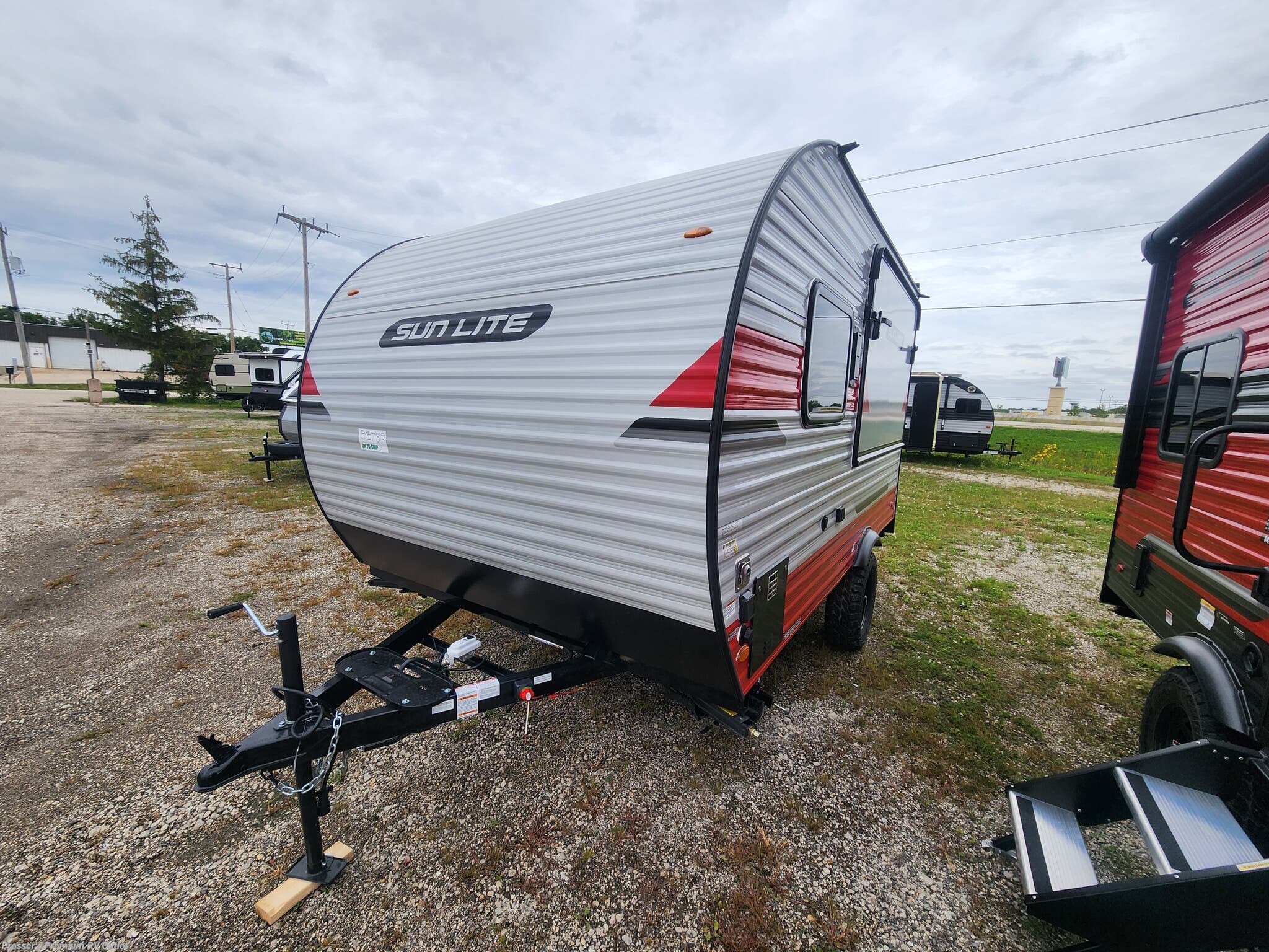2027 Sunset Park RV Sun Lite 14THX w/Patio, Rear Awning and Tip-Out - New Toy Hauler For Sale by Prosser's Premium RV Outlet in Sturtevant, Wisconsin features Refrigerator, Shower, Microwave, Water Heater, Air Conditioning