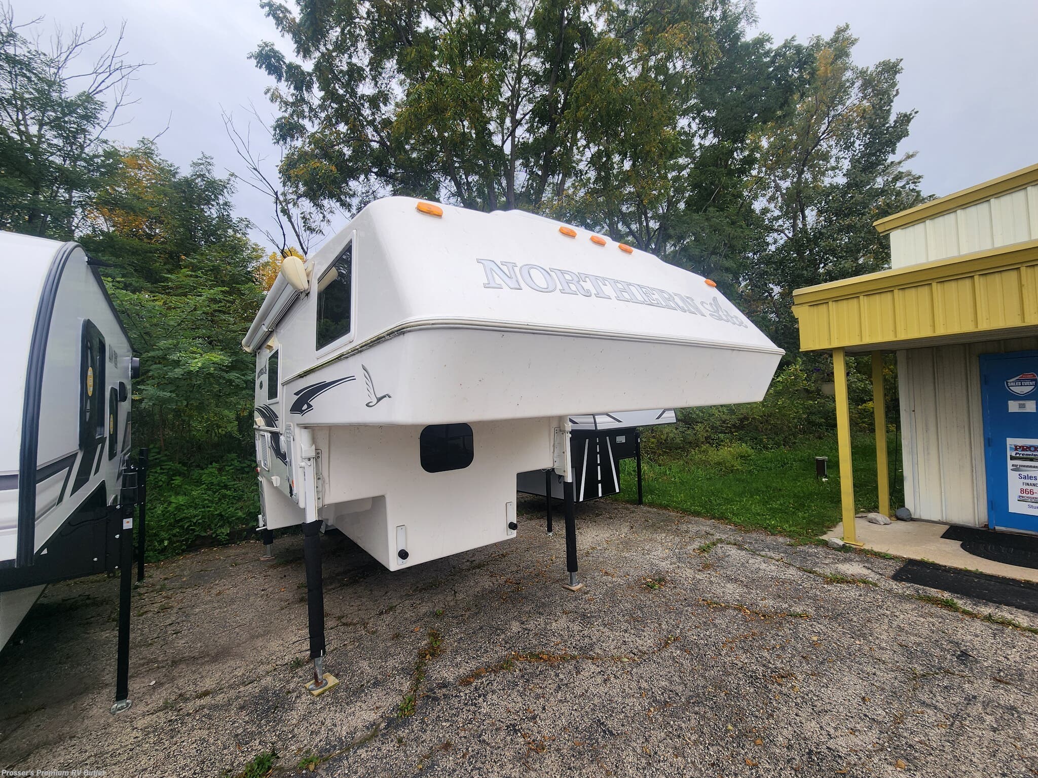 2023 Northern Lite Limited Edition 8-11 EX - Used Truck Camper For Sale by Prosser's Premium RV Outlet in Sturtevant, Wisconsin features External Shower, Furnace, LED Lights, Skylight, Generator