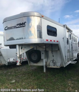
&lt;p&gt;&lt;span style=&quot;font-family: Arial, Helvetica, sans-serif; font-size: 16px;&quot;&gt;2007 Cimarron Custom built 3 horse aluminum gooseneck trailer with living quarters.&lt;/span&gt;&lt;/p&gt;
&lt;p&gt;&lt;span style=&quot;font-family: Arial, Helvetica, sans-serif; font-size: 16px;&quot;&gt;&lt;span style=&quot;font-weight: bold; font-size: 16px;&quot;&gt;Standard Features:&lt;/span&gt;&lt;br /&gt;
		- 2 - 7000# rubber torsion axles with ultra-lube hubs&lt;br /&gt;
		- 4 Wheel electric brakes&lt;br /&gt;
		- 5 - 235/85R16 LR &quot;E&quot; 10 ply radial tires&lt;br /&gt;
		- 8 Bolt Silver modular mag wheels&lt;br /&gt;
		- 2 5/16 coupler w/adjustable height stem&lt;br /&gt;
		- Safety chains with hooks&lt;br /&gt;
		- Drop-leg GN Electric/hydraulic jack w/ manual override&lt;br /&gt;
		- Design Features &amp;amp; Hardware&lt;br /&gt;
		- All aluminum construction&lt;br /&gt;
		- Fully insulated roof, 1/2&quot; thick fiberglass reinforced&amp;nbsp;structural panel with R3 thermal value.&lt;br /&gt;
		- The ultimate&amp;nbsp;in temperature control&lt;br /&gt;
		- Extruded aluminum interlocking floor&lt;br /&gt;
		- Cross members at 6&quot; centers&lt;br /&gt;
		- GN tapered nose w/18&quot; radius corners&amp;nbsp;for efficient aerodynamics&lt;br /&gt;
		- Extruded aluminum side walls on stall area&amp;nbsp;w/.050 white aluminum above&lt;br /&gt;
		- Polished Stainless steel front nose sheet&lt;br /&gt;
		- Door hold backs on all doors/gates&lt;br /&gt;
		&lt;br /&gt;
		&lt;span style=&quot;font-weight: bold; font-size: 16px;&quot;&gt;Stall Area Equipment:&lt;/span&gt;&lt;br /&gt;
		- Removable divider per two stalls with extruded head&amp;nbsp;partitions &amp;amp; quick release slam latches&lt;br /&gt;
		- Hanging divider mat on first stall divider&lt;br /&gt;
		- Fully lined and insulated&lt;br /&gt;
		- Triple wall construction with 1 3/8&quot; styrofoam insulation&lt;br /&gt;
		- .090 kick plate, &amp;amp; rubber wall mat to bottom of window&lt;br /&gt;
		- Independent rear stall doors with aluminum cam latch, cargo-vise catch &amp;amp; 15 x 22 sliding window&lt;br /&gt;
		- Spring loaded rear ramp over double rear doors&lt;br /&gt;
		- Solid alum butt bar&lt;br /&gt;
		- Heavy duty fold down feed door per stall, with heavy duty safety bar grills &amp;amp; mid height latch for easy access&lt;br /&gt;
		- Smoked glass sliding windows w/drop down face guards 15 x 22 on head side &amp;amp; 19 x 34 on butt side&lt;br /&gt;
		- Two-way aluminum flip-up roof vents, one per stall&lt;br /&gt;
		- One interior &amp;amp; one exterior tie ring per stall&lt;br /&gt;
		- 2 recessed dome lights with remote switch&lt;br /&gt;
		- Escape door with drop down feed door on first stall&lt;br /&gt;
		- Walk thru 24&quot; access door&lt;br /&gt;
		- DOT required lighting&lt;br /&gt;
		- Stop, turn, tail, marker and clearance lights&lt;br /&gt;
		- Seal beam LED tail lights&lt;br /&gt;
		&lt;span style=&quot;font-weight: bold; font-size: 16px;&quot;&gt;&lt;br /&gt;
			Rear Tack Compartment Equipment:&lt;/span&gt;&lt;br /&gt;
		- Recessed seal beam dome light w/remote switch&lt;br /&gt;
		- Removable VET type floor mat&lt;br /&gt;
		- Dimensions: 4&quot;-6&quot; long x 3&quot;-7&quot; wide&lt;br /&gt;
		- Fold-away wall between stalls &amp;amp; rear tack&lt;br /&gt;
		- Rear tack door with aluminum cam latch,cargo-vise catch &lt;br /&gt;
		- 12 J-hooks &lt;br /&gt;
		- 2 blanket bars&lt;br /&gt;
		- Adjustable 3 tier saddle rack on removable post&amp;nbsp;&lt;br /&gt;
		&lt;br /&gt;
		&lt;span style=&quot;font-weight: bold; font-size: 16px;&quot;&gt;Living Quarter Features:&lt;/span&gt;&lt;br /&gt;
		- 7&#39;3&quot; short wall&lt;br /&gt;
		- Nickel colored lighting&lt;br /&gt;
		- Screen door on entry door, pocket door to bathroom&lt;br /&gt;
		- Fresh water tank&lt;br /&gt;
		- 6 gal gas hot water tank (DSI)&lt;br /&gt;
		- Single sink in kitchen&lt;br /&gt;
		- Shower w/curtain and skydome overhead&lt;br /&gt;
		- Laminate top counter tops and table&lt;br /&gt;
		- Plastic foot flush toilet&lt;br /&gt;
		- Inner spring double size mattress w/custom fabric quilt&lt;br /&gt;
		- Sofa bed w/removable table&lt;br /&gt;
		- Solid wood window rings, cabinet doors w/raised panel&lt;br /&gt;
		- 3&quot; Crown moldings&lt;br /&gt;
		- Tank monitor system&lt;br /&gt;
		- Microwave 0.9 cu.&lt;br /&gt;
		- 2 Burner cook top recessed w/cover&lt;br /&gt;
		- Lighted/vented range hood&lt;br /&gt;
		- Overhead cabinets over sofa &amp;amp; kitchen&amp;nbsp;&lt;br /&gt;
		- Wardrobe in front nose&lt;br /&gt;
		- Carpet in bunk and step up&lt;br /&gt;
		- Vinyl flooring&lt;br /&gt;
		- Linen closet in bathroom&lt;br /&gt;
		- 3 cu. Ft refrigerator&lt;br /&gt;
		- TV shelf&lt;br /&gt;
		- 55 amp power converter&lt;br /&gt;
		- Dual 20# LPG tanks w/regulator&lt;br /&gt;
		- Dual deep cycle RV marine batteries&lt;br /&gt;
		- Exterior receptacle&lt;br /&gt;
		- Furnace&lt;br /&gt;
		- Leather touch ceiling and walls&lt;br /&gt;
		- AM/FM/CD w/interior speakers&lt;br /&gt;
		- Shades on all windows&lt;br /&gt;
		- Awning&lt;br /&gt;
		- Third party certification&lt;/span&gt;&lt;br /&gt;
	&lt;/p&gt; 