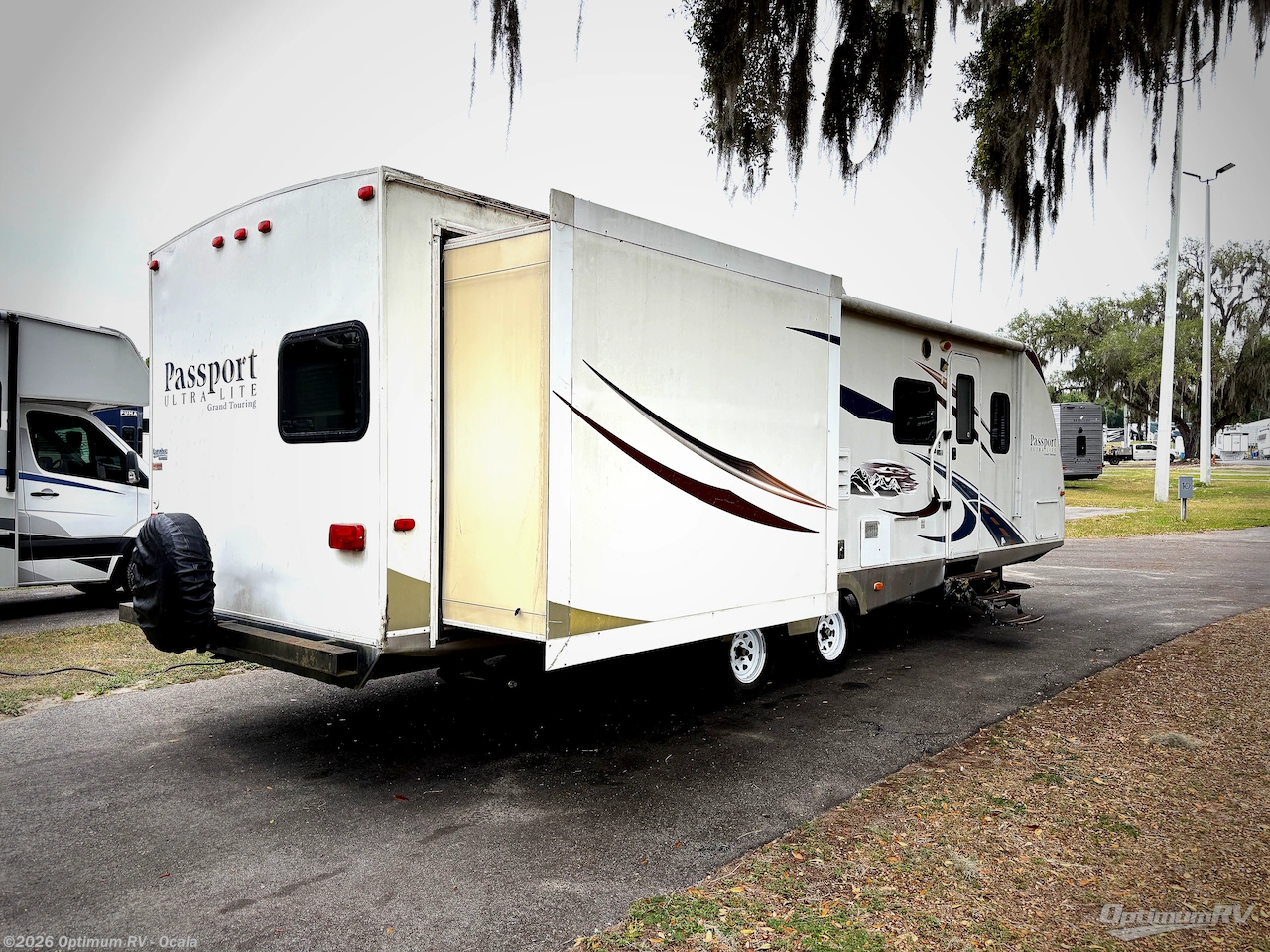 2011 Keystone Passport 2910BH Grand Touring - Used Travel Trailer For Sale by Optimum RV - Ocala in Ocala, Florida features Slideout