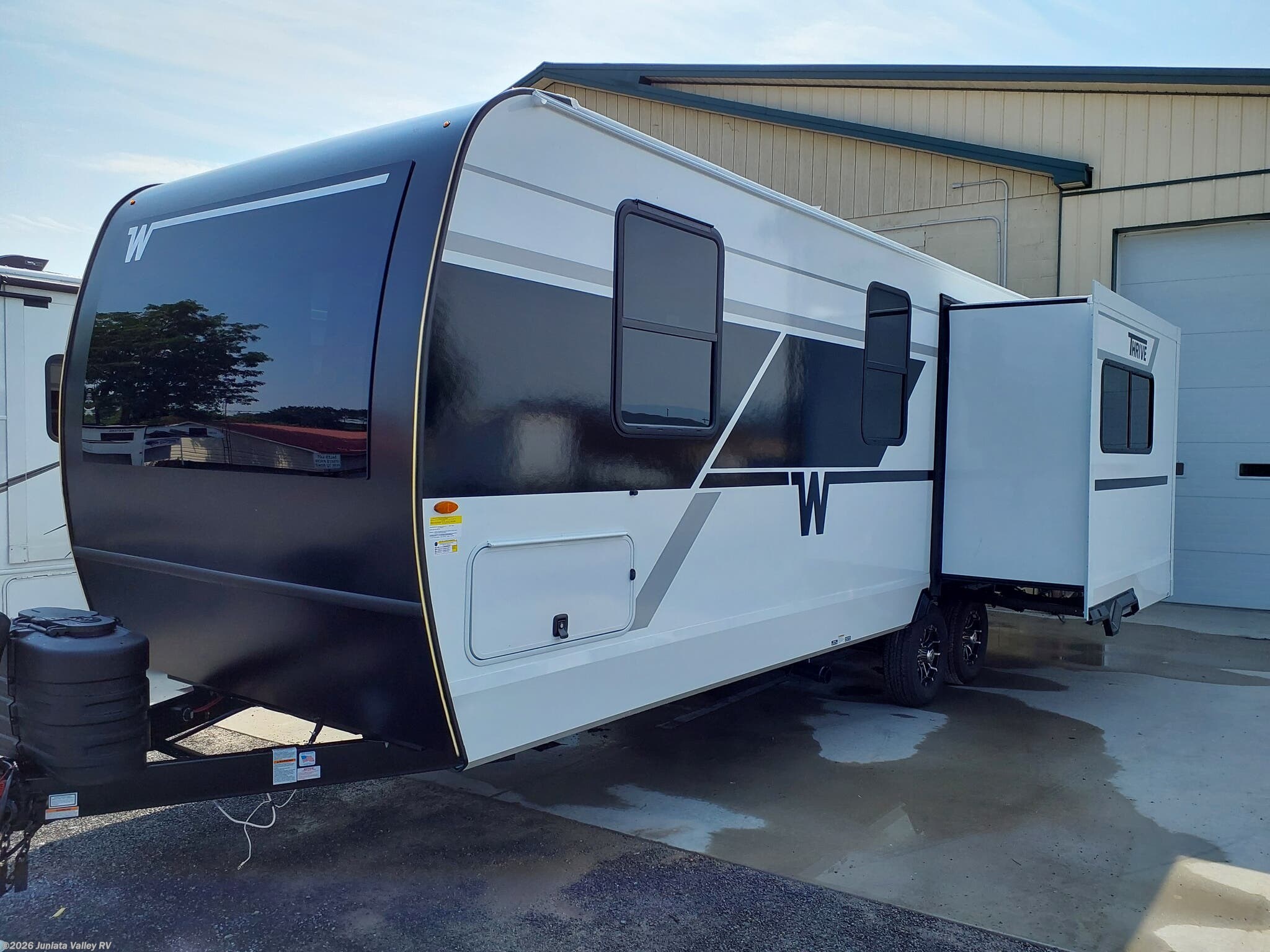 2026 Winnebago Thrive 24RKS - New Travel Trailer For Sale by Juniata Valley RV in Mifflintown, Pennsylvania features Microwave, Tankless Demand Gas Water Heater, Battery Charger, Fiberglass Sidewalls, Front Fiberglass Cap w/Window