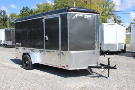 2021 HOMESTEADER 6&#39; X 12&#39; ENCLOSED CARGO TRAILER, ROUND TOP WITH WEDGE NOSE, 3.5K IDLER TORSION AXLE, 15&quot; RADIAL TIRES, WHITE VINYL WALL LINER, WHITE VINYL CEILING LINER WITH NOSECAP AND REAR HEADER ENCLOSURE, 3/4&quot; PLYWOOD FLOOR WITH BLACK MARBLE VINYL, (4) RECESSED FLOOR MOUNT D-RINGS, 16&quot; ON CENTER CROSS MEMBERS, 16&quot; ON CENTER WALL POSTS, 80&quot; INTERIOR HEIGHT, GRAY ALUMINUM EXTERIOR, 24&quot; HIGH POLISHED ALUMINUM SIDES, FLOW THRU SIDEWALL VENTS, LED LIGHTS, 24&quot; STONE GUARD ON FRONT, REAR RAMP DOOR WITH SPRING ASSIST AND WOOD FLAP, 32&quot; BONDED SIDE DOOR W/ FLUSH MOUNT LOCK AND BARLOCK, 12 VOLT LED DOME LIGHT, 2&quot; COUPLER, A-FRAME JACK.