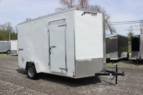 2022 HOMESTEADER 7  X 12  ENCLOSED CARGO TRAILER FOR SALE, WHITE EXTERIOR ALUMINUM, 24  V-NOSE, 32  SIDE DOOR WITH BAR LOCK, REAR RAMP DOOR WITH EXTENDED WOOD FLAP, 3/4  PLYWOOD FLOOR, (4) FLOOR MOUNT D-RINGS, 3/8  PLYWOOD WALLS, SIDE WALL FLOW THRU VENTS, DOME LIGHT, 3.5K IDLER AXLE, SPRING SUSPENSION, 15  RADIAL TIRES, LED EXTERIOR LIGHTS, 84  INTERIOR HEIGHT, 16  ON CENTER WALL POSTS, A-FRAME JACK, 2  COUPLER.