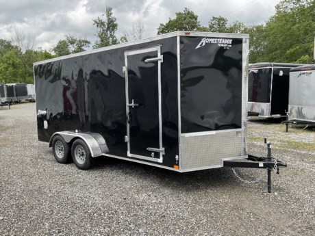2024 HOMESTEADER 7&#39; X 16&#39; ENCLOSED CARGO TRAILER, V-NOSE WITH FRONT STONEGUARD, 78&quot; INTERIOR HEIGHT, BLACK ALUMINUM EXTERIOR, 2-3.5K ELECTRIC BRAKE AXLES, SPRING SUSPENSION, 15&quot; RADIAL TIRES, 32&quot; SIDE DOOR WITH BAR LOCK, REAR RAMP DOOR WITH EXTENDED WOOD FLAP, 3/4&quot; PLYWOOD FLOOR, 3/8&quot; PLYWOOD WALLS, WHITE CEILING UNDERLAYMENT, 16&quot; ON CENTER FLOOR CROSSMEMBERS, 16&quot; ON CENTER WALL POSTS, (4) FLOOR MOUNT D-RINGS, FLOW THRU VENTS - SIDEWALL, DOME LIGHT, LED EXTERIOR LIGHTS, 2-5/16&quot; COUPLER, A-FRAME JACK.