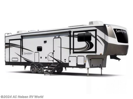 &lt;p&gt;&lt;strong&gt;Forest River Sandpiper fifth wheel 4002FB highlights:&lt;/strong&gt;&lt;/p&gt; &lt;ul&gt; &lt;li&gt;Two Bedrooms&lt;/li&gt; &lt;li&gt;Loft Above Rear Bedroom and Bath&lt;/li&gt; &lt;li&gt;Two Full Baths&lt;/li&gt; &lt;li&gt;Theater Seating&lt;/li&gt; &lt;li&gt;Kitchen Island&lt;/li&gt; &lt;/ul&gt; &lt;p&gt;&#160;&lt;/p&gt; &lt;p&gt;Weekend camping trips and full-time RV living is made complete in this quad slide out fifth wheel. Your crew can relax under the 15&#39; electric awning, or head inside to enjoy the fireplace. There is also a &lt;strong&gt;50&quot; flat screen TV&lt;/strong&gt; across from the &lt;strong&gt;theater seating&lt;/strong&gt;, plus a free-standing dinette to dine at. There are two full baths with the front bath including a &lt;strong&gt;walk-in shower with a seat&lt;/strong&gt; for your comfort, and the front private bedroom will feel just like home with its queen bed and large front wardrobe. There is even washer and dryer prep to make laundry day easier than ever. The master bedroom in back includes a &lt;strong&gt;second queen bed slide out&lt;/strong&gt;, and the&lt;strong&gt; rear full bath&lt;/strong&gt; has another convenience with it&#39;s exterior entry door, and&#160;&lt;/p&gt; &lt;p&gt;&#160;&lt;/p&gt; &lt;p&gt;You will find the perfect balance of size, space, features, and luxury with any one of these Forest River Sandpiper fifth wheels! They are constructed with a welded aluminum framed vacuum bonded &lt;strong&gt;laminated superstructure&lt;/strong&gt;, a cambered powder coated frame with rust prohibitor, and a fully enclosed underbelly to protect the units vitals during any season. The &lt;strong&gt;large tinted windows&lt;/strong&gt; come with a 80/20 UV prohibitor or you can choose the optional dual pane windows. Some hassle-free amenities include a 60k BTU &lt;strong&gt;on-demand water heater&lt;/strong&gt;, full coach water filter system, tire pressure monitor system, and an electric leveling system! Inside, you&#39;ll enjoy &lt;strong&gt;stainless steel appliances&lt;/strong&gt;, solid surface countertops, upgraded raised panel cabinet doors, and rustic wood plank linoleum to name a few comforts!&lt;/p&gt; &lt;p&gt;&#160;&lt;/p&gt;&lt;ul&gt;&lt;li&gt;Front Bedroom&lt;/li&gt;&lt;li&gt;Rear Bath&lt;/li&gt;&lt;li&gt;Two Entry/Exit Doors&lt;/li&gt;&lt;li&gt;Kitchen Island&lt;/li&gt;&lt;li&gt;Loft&lt;/li&gt;&lt;li&gt;Two Full Baths&lt;/li&gt;&lt;/ul&gt;&lt;ul&gt;&lt;li&gt;CHEF&#39;S KITCHEN&lt;/li&gt;&lt;li&gt; SUMMIT PACKAGE&lt;/li&gt;&lt;/ul&gt;