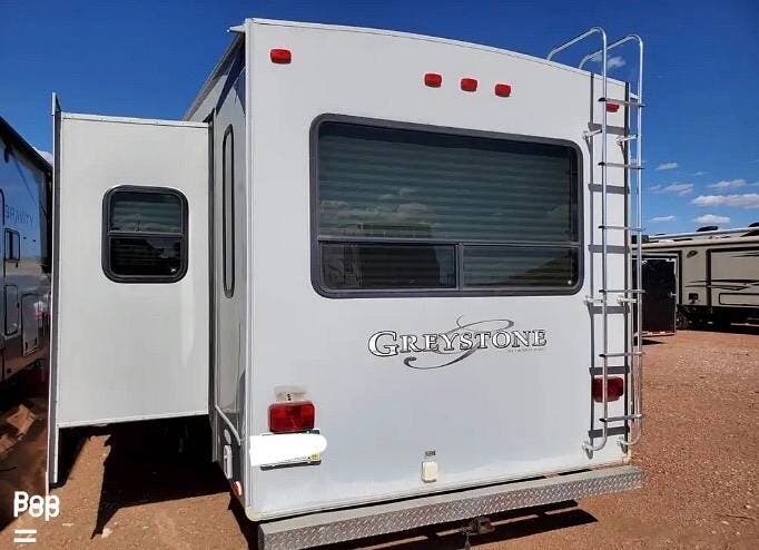 2012 Heartland Greystone 32RL - Used Fifth Wheel For Sale by Pop RVs in Colorado Springs, Colorado features Air Conditioning, Slideout, Leveling Jacks, Awning