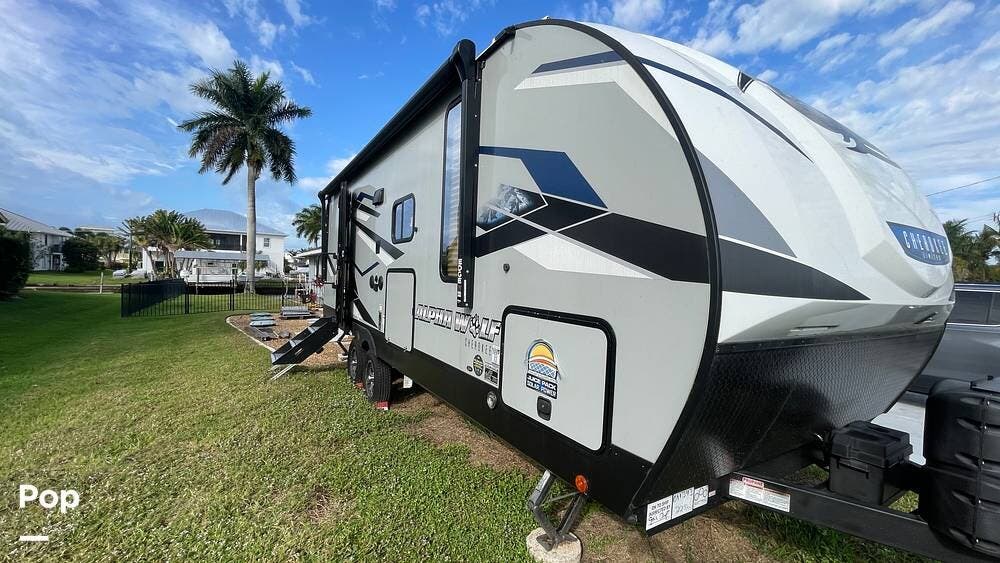 2023 Cherokee Alpha Wolf 22SW-L - Used Travel Trailer For Sale by Pop RVs in Fort Myers, Florida features Awning, Leveling Jacks, Slideout, Air Conditioning