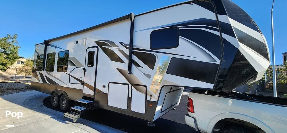 2022 Dutchmen Voltage Triton 3351 - Toy Hauler - Used Toy Hauler For Sale by Pop RVs in North Las Vegas, Nevada features Leveling Jacks, Air Conditioning, Awning, Slideout