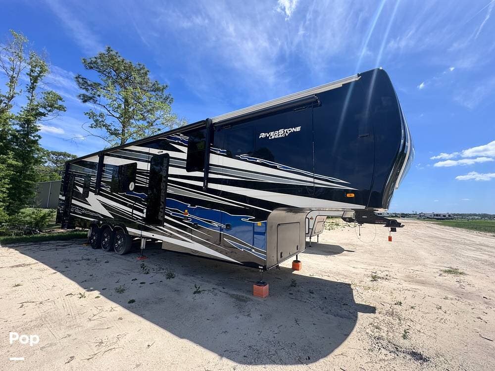2023 Forest River RiverStone 45BATH Toy Hauler - Used Toy Hauler For Sale by Pop RVs in Ocala, Florida features Leveling Jacks, Air Conditioning, Generator, Awning, Slideout