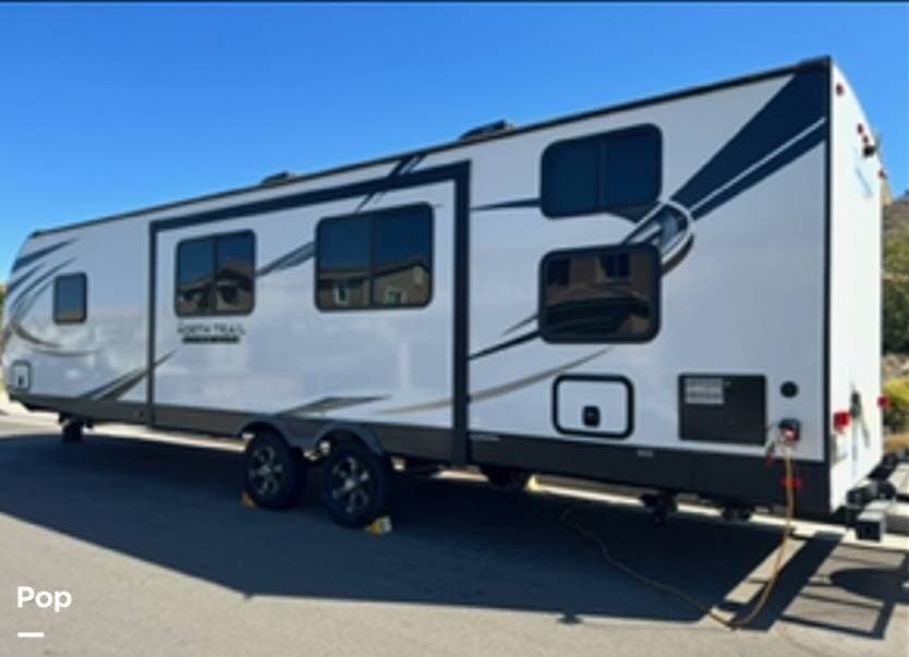 2020 Heartland North Trail 31BHDD - Used Travel Trailer For Sale by Pop RVs in Beaumont, California features Awning, Slideout, Leveling Jacks, Air Conditioning