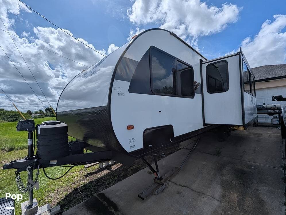2024 Forest River Wildwood X-Lite 28VBXL - Used Travel Trailer For Sale by Pop RVs in North Port, Florida features Air Conditioning, Leveling Jacks, Slideout, Awning