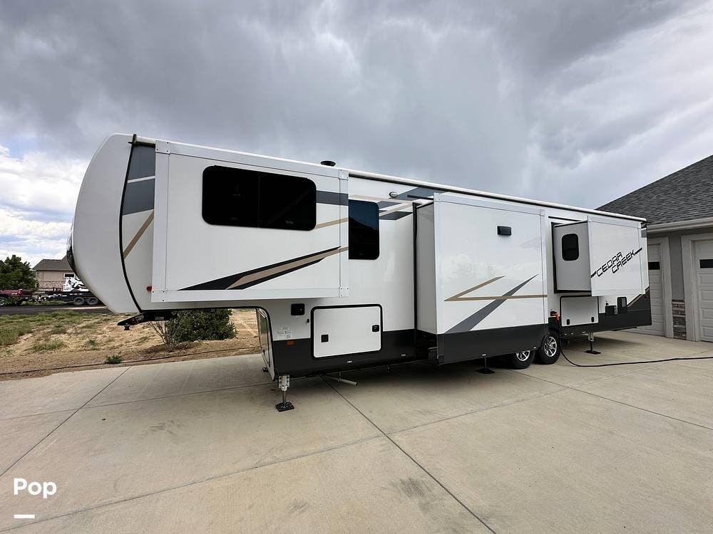 2022 Forest River Cedar Creek 371FL - Used Fifth Wheel For Sale by Pop RVs in Berthoud, Colorado features Awning, Generator, Leveling Jacks, Air Conditioning, Slideout