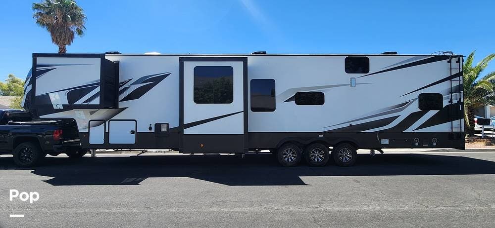 2021 Dutchmen Voltage 4225 Toy Hauler - Used Toy Hauler For Sale by Pop RVs in Henderson, Nevada features Leveling Jacks, Awning, Generator, Air Conditioning, Slideout