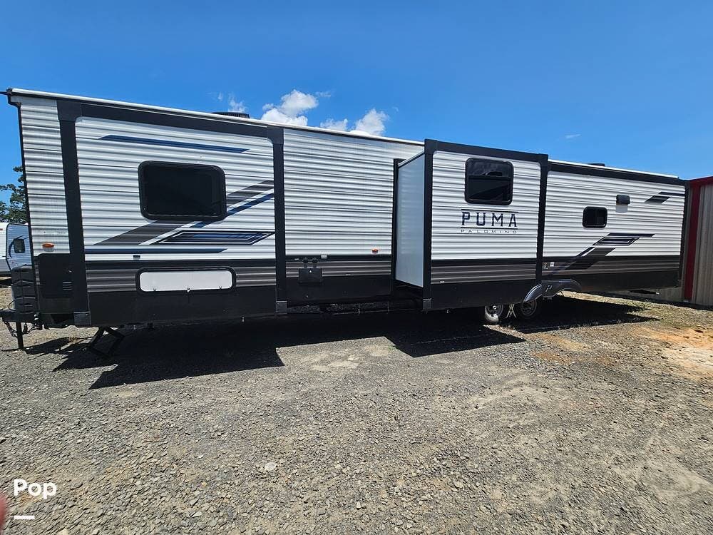 2023 Palomino Puma 38RLB - Used Travel Trailer For Sale by Pop RVs in Sherwood, Arkansas features Awning, Slideout, Air Conditioning, Leveling Jacks