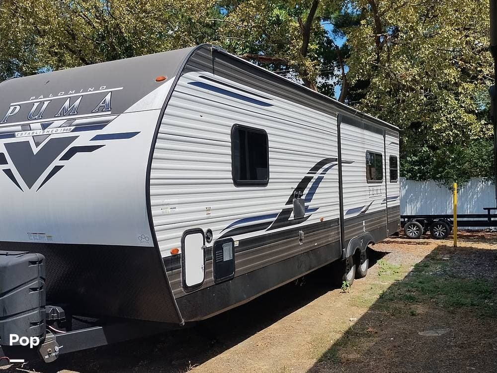 2023 Palomino Puma 26RLS - Used Travel Trailer For Sale by Pop RVs in Fort Smith, Arkansas features Leveling Jacks, Awning, Air Conditioning, Slideout