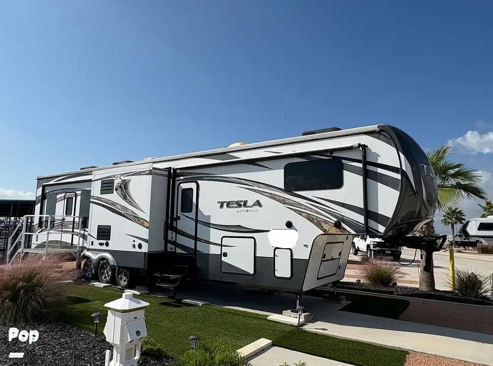 2015 Buck's Tiny Houses Evergreen Tesla T3950 - Used Toy Hauler For Sale by Pop RVs in Rockport, Texas features Awning, Leveling Jacks, Air Conditioning, Generator, Slideout