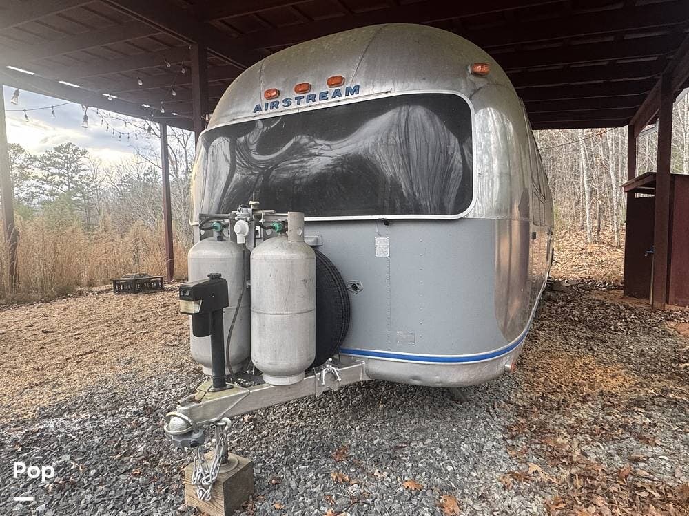 1977 Airstream Sovereign 31 - Used Travel Trailer For Sale by Pop RVs in Mineral Bluff, Georgia features Leveling Jacks, Air Conditioning, Awning