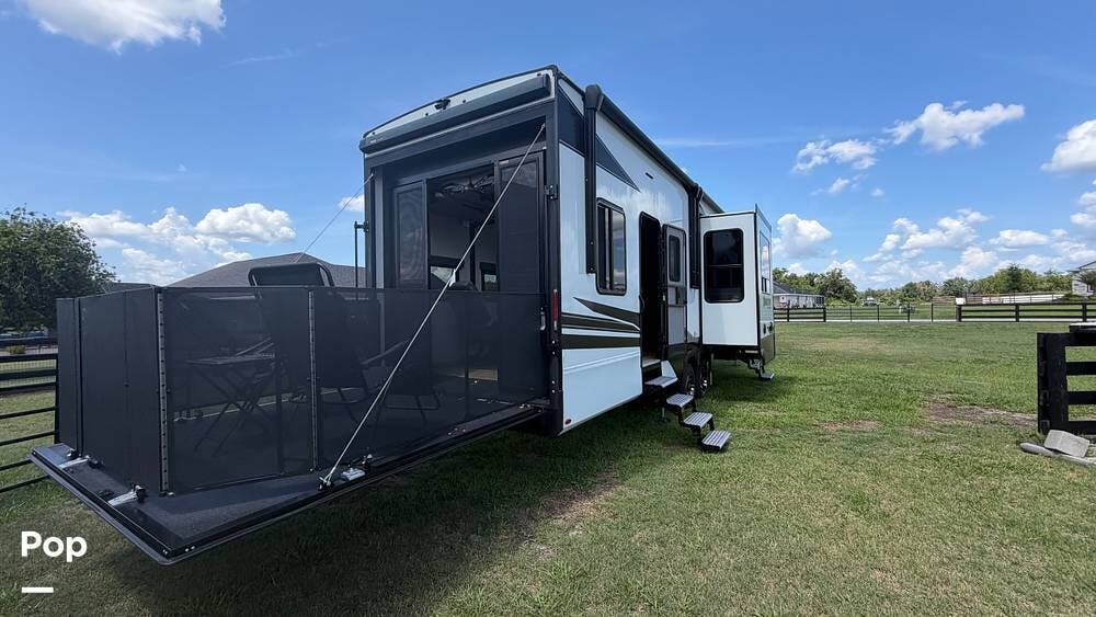 2023 Grand Design Momentum 350G - Used Toy Hauler For Sale by Pop RVs in Wildwood, Florida features Leveling Jacks, Awning, Generator, Slideout, Air Conditioning