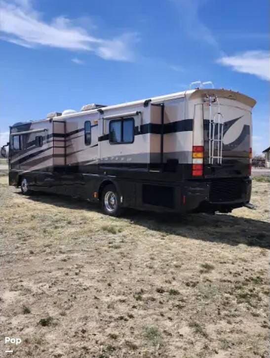 2003 Fleetwood Revolution 40C - Used Diesel Pusher For Sale by Pop RVs in Aurora, Colorado features Leveling Jacks, Awning, Generator, Air Conditioning, Slideout