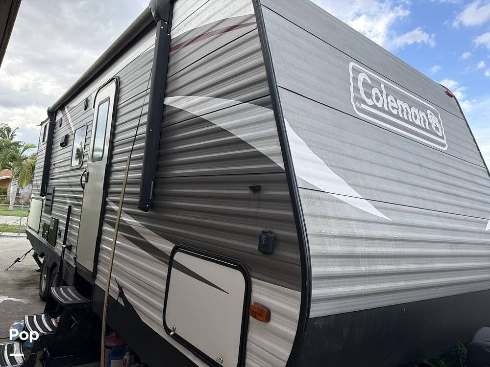 2019 Coleman Lantern 244BH - Used Travel Trailer For Sale by Pop RVs in Miami Gardens, Florida features Awning, Leveling Jacks, Slideout, Air Conditioning
