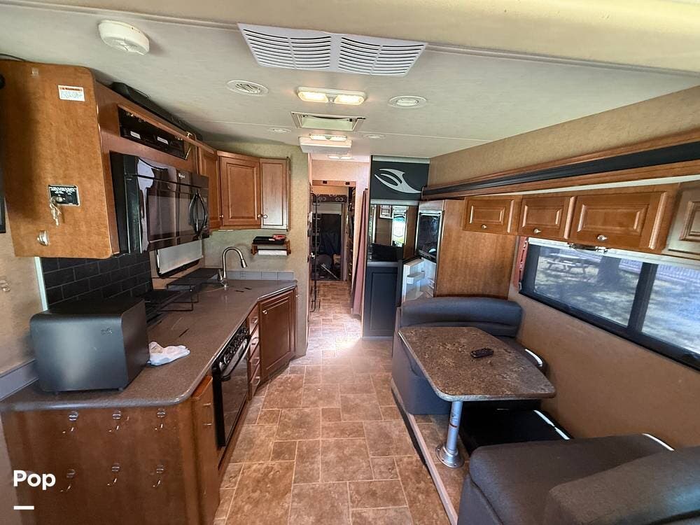 2015 Thor Motor Coach Outlaw 37MD - Used Toy Hauler For Sale by Pop RVs in Pipe Creek, Texas features Leveling Jacks, Generator, Awning, Air Conditioning, Slideout