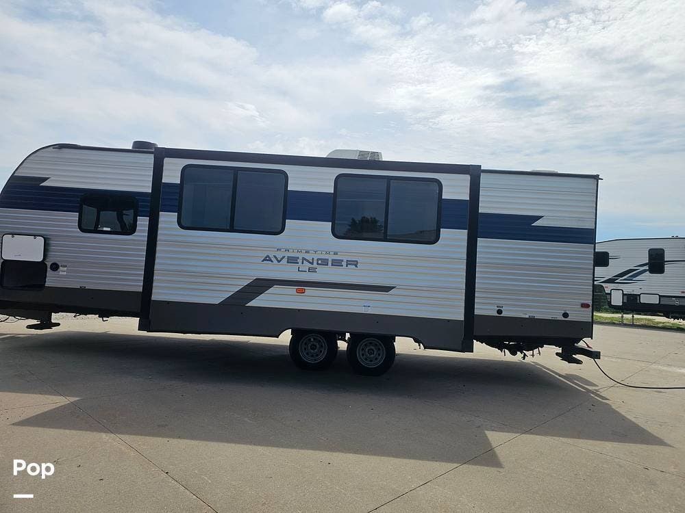 2022 Prime Time Avenger LE 26DBS - Used Travel Trailer For Sale by Pop RVs in Colfax, Iowa features Awning, Air Conditioning, Leveling Jacks, Slideout