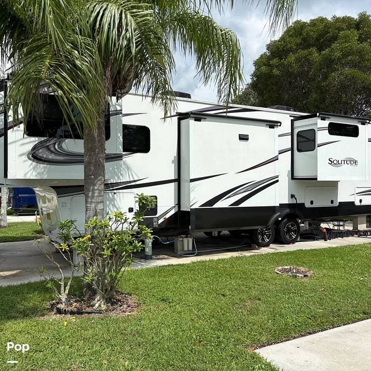 2023 Grand Design Solitude 380FL - Used Fifth Wheel For Sale by Pop RVs in Naples, Florida features Awning, Leveling Jacks, Slideout, Air Conditioning