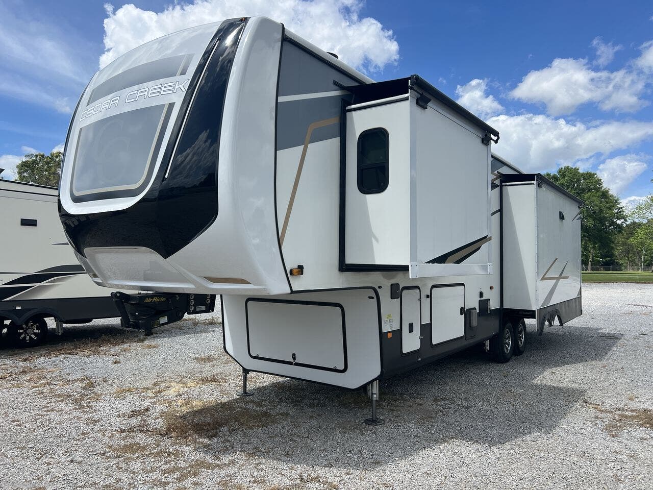 2021 Forest River Cedar Creek 345IK - Used Fifth Wheel For Sale by Courvelle's RV in Opelousas, Louisiana features Day/Night Shades, Solid Surface Countertops, Central Vacuum, Microwave, Tinted Windows
