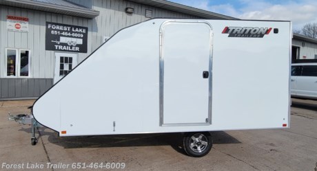 &lt;p&gt;&lt;span style=&quot;font-size: 20px;&quot;&gt;&lt;strong&gt;2024 Triton TC-128 Enclosed Aluminum 2 Place Sled Trailer&lt;/strong&gt;&lt;/span&gt;&lt;/p&gt;
&lt;p&gt;&lt;span style=&quot;font-size: 14px;&quot;&gt;UPGRADE - Aluminum Wheels&amp;nbsp;&lt;/span&gt;&lt;/p&gt;
&lt;p&gt;&lt;span style=&quot;font-size: 14px;&quot;&gt;UPGRADE - Ski Guides &amp;amp; Grips&lt;/span&gt;&lt;/p&gt;
&lt;ul&gt;
&lt;li&gt;2 Place sled trailer&lt;/li&gt;
&lt;li&gt;Dual air vents for air flow and moisture control.&lt;/li&gt;
&lt;li&gt;Roof is contoured for improved towing aerodynamics reducing gas consumption.&lt;/li&gt;
&lt;li&gt;Highly visible sealed LED lights on entire trailer.&lt;/li&gt;
&lt;li&gt;Double seal door design prevents leaks, keeps cargo area dry.&lt;/li&gt;
&lt;li&gt;Flexible rubber bridge between ramp door and deck to keep hinge area free of debris.&lt;/li&gt;
&lt;li&gt;Build in transition for smooth loading.&lt;/li&gt;
&lt;/ul&gt;
&lt;p style=&quot;text-align: center;&quot;&gt;&lt;strong&gt;Call our Sales Team for more information!&lt;/strong&gt;&lt;/p&gt;
&lt;p style=&quot;text-align: center;&quot;&gt;&lt;strong&gt;651-464-6009&lt;/strong&gt;&lt;/p&gt;
&lt;p style=&quot;text-align: center;&quot;&gt;&lt;strong&gt;www.FORESTLAKETRAILER.com&lt;/strong&gt;&lt;/p&gt;
&lt;p style=&quot;text-align: center;&quot;&gt;&lt;strong&gt;Forest Lake Trailer&lt;/strong&gt;&lt;/p&gt;
&lt;p style=&quot;text-align: center;&quot;&gt;&lt;strong&gt;651-464-6009&lt;/strong&gt;&lt;/p&gt;
&lt;p style=&quot;text-align: center;&quot;&gt;&lt;strong&gt;15131 Feller Street&lt;/strong&gt;&lt;/p&gt;
&lt;p style=&quot;text-align: center;&quot;&gt;&lt;strong&gt;Forest Lake, MN. 55025&lt;/strong&gt;&lt;/p&gt;
&lt;p style=&quot;text-align: center;&quot;&gt;&lt;strong&gt;Call for availability as our inventory is always changing.&lt;/strong&gt;&lt;/p&gt;
&lt;p style=&quot;text-align: center;&quot;&gt;&lt;strong&gt;Large selection of trailers in stock ready for immediate delivery.&lt;/strong&gt;&lt;/p&gt;
&lt;p style=&quot;text-align: left;&quot;&gt;&lt;strong&gt;Financing terms are simply an estimate&amp;nbsp;and are by no means a commitment to a specific interest rate or term. &amp;nbsp;Forest Lake Trailer is not responsible for any typos, errors or misprints found in our ads.&lt;/strong&gt;&lt;/p&gt;