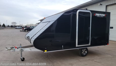 &lt;p&gt;&lt;span style=&quot;font-size: 18pt;&quot;&gt;&lt;strong&gt;2024 Triton TC-128 Enclosed Aluminum 2 Place Sled Trailer&lt;/strong&gt;&lt;/span&gt;&lt;/p&gt;
&lt;p&gt;&lt;span style=&quot;font-size: 14px;&quot;&gt;UPGRADE - Aluminum Wheels&amp;nbsp;&lt;/span&gt;&lt;/p&gt;
&lt;p&gt;&lt;span style=&quot;font-size: 14px;&quot;&gt;UPGRADE - Ski Guides &amp;amp; Grips&lt;/span&gt;&lt;/p&gt;
&lt;ul&gt;
&lt;li&gt;2 Place sled trailer&lt;/li&gt;
&lt;li&gt;Dual air vents for air flow and moisture control.&lt;/li&gt;
&lt;li&gt;Roof is contoured for improved towing aerodynamics reducing gas consumption.&lt;/li&gt;
&lt;li&gt;Highly visible sealed LED lights on entire trailer.&lt;/li&gt;
&lt;li&gt;Double seal door design prevents leaks, keeps cargo area dry.&lt;/li&gt;
&lt;li&gt;Flexible rubber bridge between ramp door and deck to keep hinge area free of debris.&lt;/li&gt;
&lt;li&gt;Build in transition for smooth loading.&lt;/li&gt;
&lt;/ul&gt;
&lt;p style=&quot;text-align: left;&quot;&gt;&lt;strong&gt;5 Year Manufacturers Limited Warranty&lt;/strong&gt;&lt;/p&gt;
&lt;p style=&quot;text-align: center;&quot;&gt;&lt;strong&gt;Call our Sales Team for more information!&lt;/strong&gt;&lt;/p&gt;
&lt;p style=&quot;text-align: center;&quot;&gt;&lt;strong&gt;651-464-6009&lt;/strong&gt;&lt;/p&gt;
&lt;p style=&quot;text-align: center;&quot;&gt;&lt;strong&gt;www.FORESTLAKETRAILER.com&lt;/strong&gt;&lt;/p&gt;
&lt;p style=&quot;text-align: center;&quot;&gt;&lt;strong&gt;Forest Lake Trailer&lt;/strong&gt;&lt;/p&gt;
&lt;p style=&quot;text-align: center;&quot;&gt;&lt;strong&gt;651-464-6009&lt;/strong&gt;&lt;/p&gt;
&lt;p style=&quot;text-align: center;&quot;&gt;&lt;strong&gt;15131 Feller Street&lt;/strong&gt;&lt;/p&gt;
&lt;p style=&quot;text-align: center;&quot;&gt;&lt;strong&gt;Forest Lake, MN. 55025&lt;/strong&gt;&lt;/p&gt;
&lt;p style=&quot;text-align: center;&quot;&gt;&lt;strong&gt;Call for availability as our inventory is always changing.&lt;/strong&gt;&lt;/p&gt;
&lt;p style=&quot;text-align: center;&quot;&gt;&lt;strong&gt;Large selection of trailers in stock ready for immediate delivery.&lt;/strong&gt;&lt;/p&gt;
&lt;p style=&quot;text-align: left;&quot;&gt;&lt;strong&gt;Financing terms are simply an estimate&amp;nbsp;and are by no means a commitment to a specific interest rate or term. &amp;nbsp;Forest Lake Trailer is not responsible for any typos, errors or misprints found in our ads.&lt;/strong&gt;&lt;/p&gt;