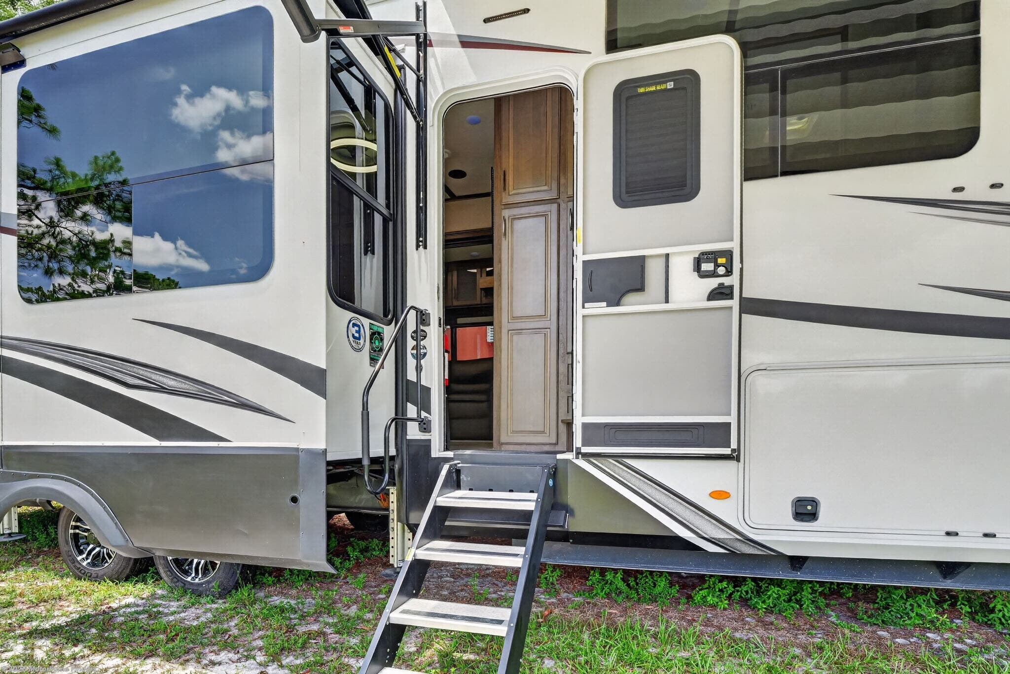 2022 Grand Design Solitude 390RK - Used Fifth Wheel For Sale by Motorhome Finders in Fort Myers, Florida features Fire Extinguisher, Stainless Appliances, Inverter, Backup Monitor, Backup Camera