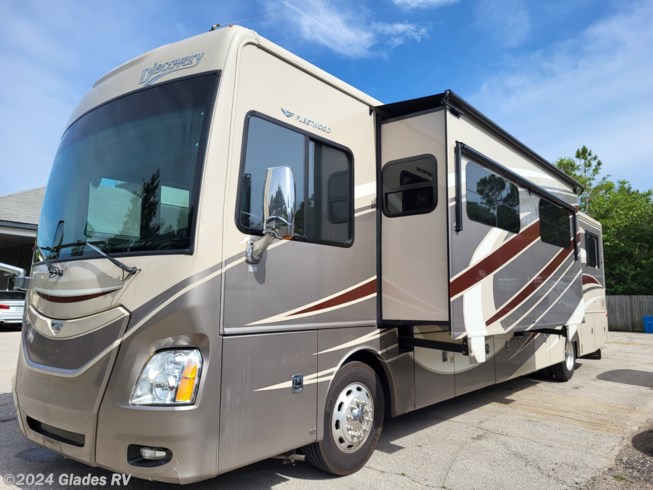 2015 Fleetwood Discovery 40X - Used Diesel Pusher For Sale by Glades RV in Fort Myers, Florida features Residential Refrigerator, Solid Surface Countertops, L Sofa, Full Body Paint, Automatic Leveling Jacks