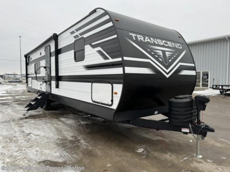 In pursuit of family fun on the road? Look no further than this New 2024 Grand Design Transcend XPLOR 297QB! Stock #829989.

Virtual Tour-https://virtualtour.granddesignrv.com/tours/p9oTNiBIX

Exterior Features:

EXTERIOR
Power Tongue Jack
Solar Power Inlet
Black Tank Flush
20# LP Bottles (2) with Cover
Friction Hinge Entry Door
Walk-on Roof
Easy Access Low Point Drain Valves
Spare Tire w/ Carrier
Magnetic Storage Door Catches
Extended Grab Handle
Rear Ladder
Tinted Windows
Upgraded STRONGWALL Metal Exterior
 
CONSTRUCTION
TPO Roof Membrane w/ Limited Lifetime Warranty
Insulated Storage Doors
Rear Wall Insulation (R-9)
Side Walls Insulation (R-9)
Slideroom Roof and End Wall Insulation (R-9)
Main Floor Insulation (R-11)
Roof Insulation (R-40)
Heated and Enclosed Underbelly w/ Suspended Tanks
Designated Heat Duct to Subfloor
Thermofoil over Roof &amp; Front Cap
Moisture Barrier Floor Enclosure
 
ELECTRICAL
Battery Kill Switch (Pass Thru)
USB Ports (2)
More Power Outlets
Dimmable LED Strip Lighting
Power Awning
Detachable Power Cord w/ LED Light
Motion Sensor Lights in Key Areas
165W Roof Mounted Solar Panel
Roof Mounted Quick Connect Plugs
40 AMP Charge Controller with Bluetooth
Solar Disconnect

Interior Features:
INTERIOR
Large Solid Bedroom Door (Master Suite)
Power Vent Fan in Bath and Living Room
Solid Hardwood Drawer Fronts
Solid Core Cabinet Stiles
Pre-Drilled and Screwed Cabinetry
Ball Bearing Full Extension Drawer Glides
Residential Countertops
Upgraded Residential Furniture
78&quot; Interior Height
 
KITCHEN
Residential Booth Dinette
Residential Cabinet Doors
Deep Seated Stainless Steel Sink
 
BEDROOM
Residential Bedspread
Master Suite w/ 60&quot; x 80&quot; Queen Bed
E-Z Lift Bed Storage w/ Struts
 
BATHROOM
Walk-in Shower
Medicine Cabinet with Mirror
ABS Tub Surround
Foot Flush Toilet
PLUMBING
High-Capacity Water Pump
Extra Large 2&quot; Fresh Water Drain Valve
Oversized Tank Capacites
56 Gallon Fresh Water Capacity
High Rise Faucet with Pull Down Sprayer
E-Z Winterization
All-in-One Utility Center
 
ELECTRONICS
Cable/Sat Prep
AM/FM/Bluetooth Stereo
Exterior Speakers
Backup Camera Prep
HD LED TV
HD TV Antenna
 
APPLIANCE
Microwave
3-Burner Range with Oven
12V 8 Cu. Ft. Refrigerator
 
HVAC
35K BTU High Capacity Furnace
Attic Vent
Main A/C Ducted
EvenFlow Ductless Heating System Throughout

Specifications:

OVERALL SIZE
Exterior Height11&#39;
Exterior Height (w/opt. AC) N/A
Exterior Length35&#39; 11&quot;
Exterior Width8&#39;
Exterior Width (w/ slide out)11&#39;
Interior Height78
WEIGHTS
Hitch / Pin Weight803
UVW7,383
GVWR8,995
CAPACITY
Fresh Water Capacity56
Grey Water Capacity78
Waste Water Capacity39
Propane Tanks2
LPG40
Sleeping Capacity10
APPLIANCES
Water HeaterTankless 
Refrigerator8 cu. ft.
Furnace35 BTU
AC15,000 BTU
RUNNING GEAR
Axles2
Wheel Size15 in.
Tire SizeST225/75R15LRE
CONSTRUCTION
Construction TypeTraditional
Floor R-ValueR-11
Wall R-ValueR-9
Roof R-ValueR-40
Slide Room R-ValueR-9
DIMENSIONS
Standard Bed60 X 80 Queen Bed
Standard Bunk32&quot; x 72&quot;
Shower27&quot; x 36&quot;
EXTERIOR
Slides1
Awnings1
Awning Length20&#39;


Popular Accessories Add-Ons:
Owner&#39;s Kit
Water Filtration System
Exterior Ladder Upgrade
Maxx Air Vent Covers
Backup Cameras
Generators
Much, Much More

Ultimate Transportation in Fargo, ND provides a full line of camper parts and RV accessories along with a full RV service department. A few of these services include winterization, diagnostics, general repair, aftermarket installation, and much more. 

Not seeing the floorplan you&#39;re looking for? We&#39;re happy to work with you to order the custom camper, toy hauler, or ice house that&#39;s right for you. We have a variety of manufacturers such as Grand Design RV, Heartland RV, Forest River XLR Toy Haulers, Ice Castle Rugged RV, and Team Lodge. Check out our showrooms here: https://www.ultimate-transportation.com/recreation/showroom. 
Give us a call at 701-282-6060 or fill out a request form on our website to have our recreational sales team get in contact with you.