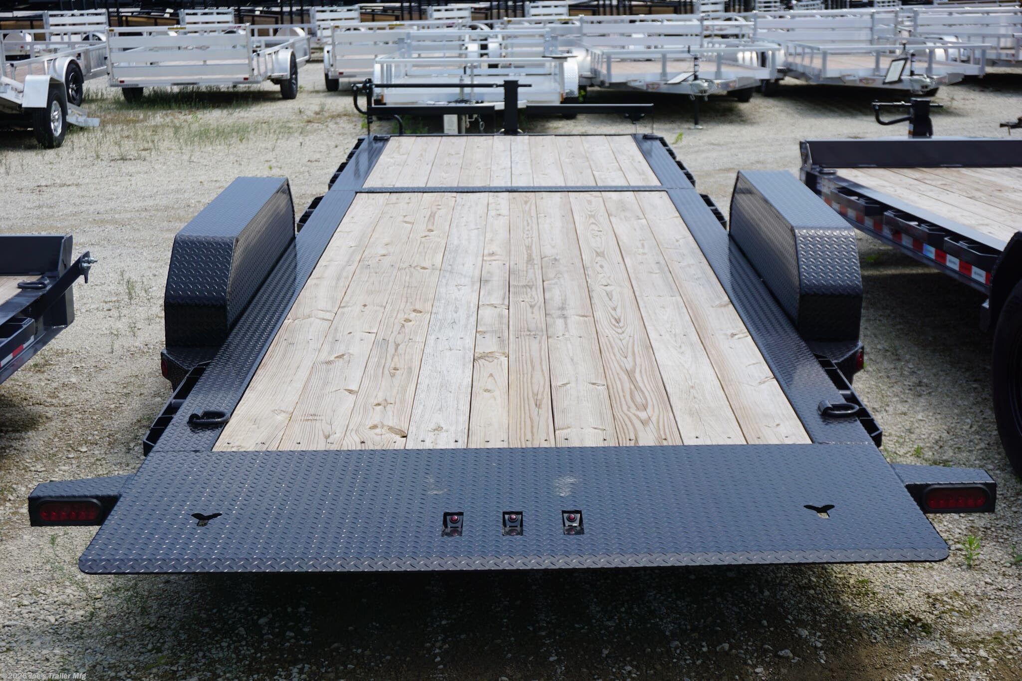 Ironbull TLB8324 Tilt Bed Equipment Trailer, heavy-duty trailer, equipment trailer, durable trailer, easy-to-use trailer, robust construction, reliable performance, transporting equipment, 6" channel tongue, 20" deck height, 11-degree loading angle, knife edge tail, Sherwin-Williams Powdura powder coat, formed 3 x 3/16" channel cross members, removable diamond plate fenders, rub rail, stake pockets, 4 standard 3" D-rings, 5200 lb torsion axles, 7000 lb torsion axles, cambered torsion axles, multi-leaf slipper spring suspension, 2 5/16" adjustable coupler, 10k drop-leg jack, radial tires, E-Z Lube hubs, 3" x 10" cylinder, 1.5" shaft, treated pine floor, lifetime LED lighting, DOT approved lighting, molded sealed harness with resistors, 7-way receiver female plug, adapter, trailer features, trailer specifications, trailer durability, trailer ease of use, trailer performance, trailer construction, trailer lighting, trailer flooring, trailer axles, trailer suspension, trailer coupler, tra