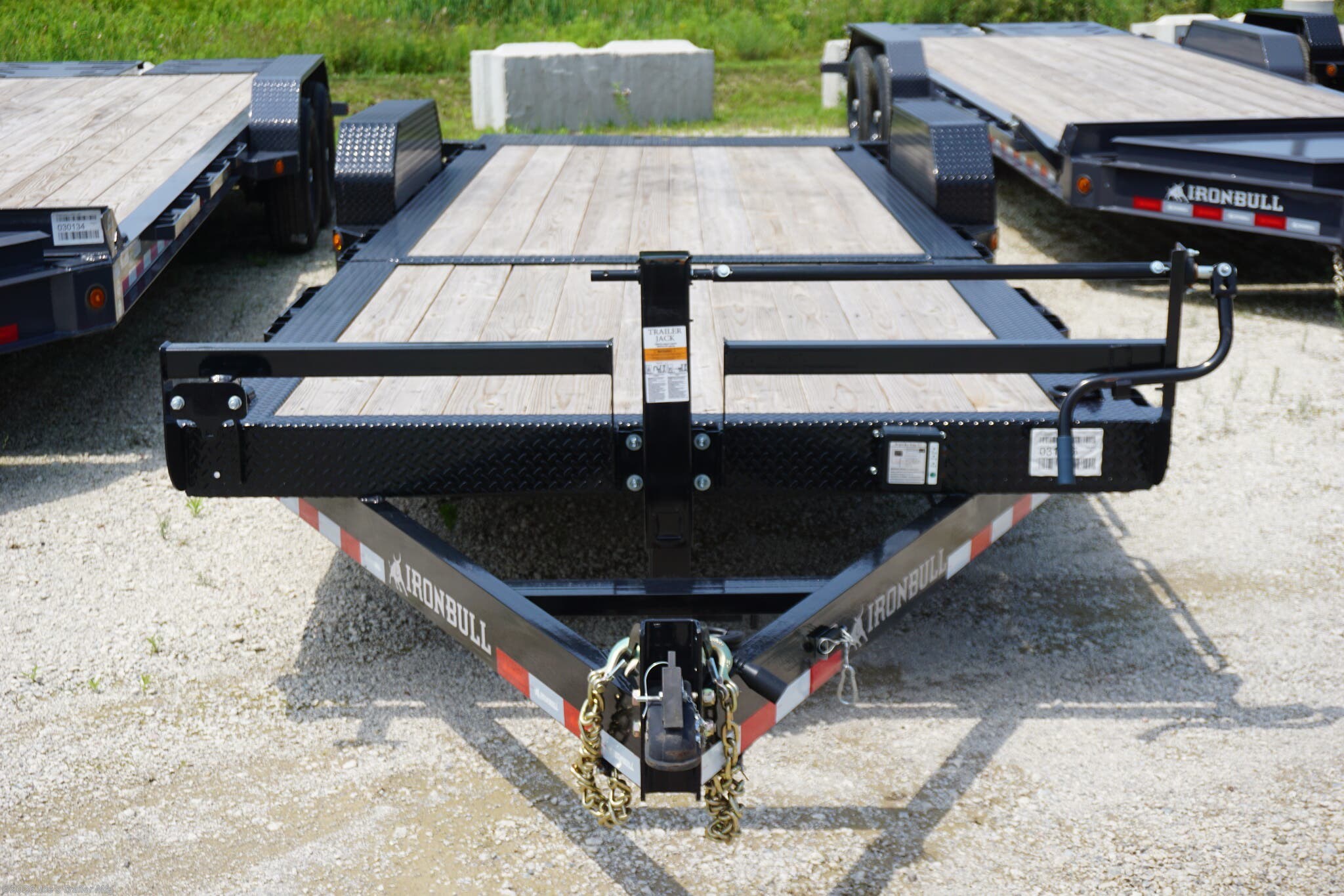 Ironbull TLB8324 Tilt Bed Equipment Trailer, heavy-duty trailer, equipment trailer, durable trailer, easy-to-use trailer, robust construction, reliable performance, transporting equipment, 6" channel tongue, 20" deck height, 11-degree loading angle, knife edge tail, Sherwin-Williams Powdura powder coat, formed 3 x 3/16" channel cross members, removable diamond plate fenders, rub rail, stake pockets, 4 standard 3" D-rings, 5200 lb torsion axles, 7000 lb torsion axles, cambered torsion axles, multi-leaf slipper spring suspension, 2 5/16" adjustable coupler, 10k drop-leg jack, radial tires, E-Z Lube hubs, 3" x 10" cylinder, 1.5" shaft, treated pine floor, lifetime LED lighting, DOT approved lighting, molded sealed harness with resistors, 7-way receiver female plug, adapter, trailer features, trailer specifications, trailer durability, trailer ease of use, trailer performance, trailer construction, trailer lighting, trailer flooring, trailer axles, trailer suspension, trailer coupler, tra
