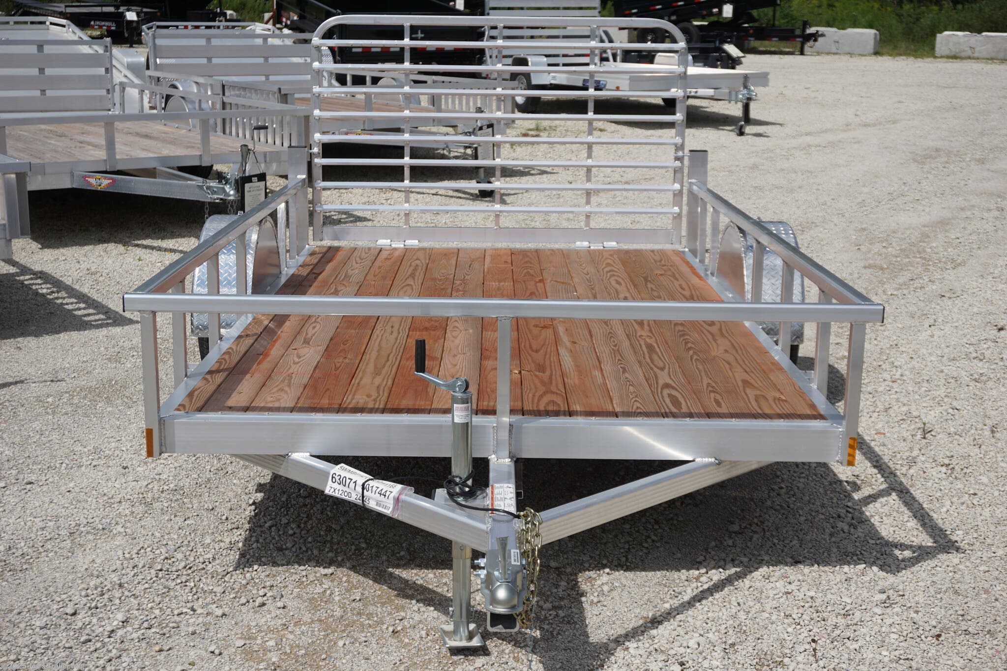 Legend 7x12 Open Deluxe Utility Trailer, 17" deck height utility trailer, 48" ramp gate trailer, 3.5k EZ-Lube spring axle, ST205/75R14 Silver Mod steel tires, 3" tube cross members, 24" on center cross member spacing, 4" tube frame trailer, aluminum flooring utility trailer, LED lighting trailer, 2" straight coupler, 2k top-wind jack, ATP fenders, stake pockets, aluminum utility trailer, open deluxe trailer, Legend utility trailer, lightweight utility trailer, durable trailer frame, trailer with LED lights, easy-to-lube axle, high-quality utility trailer, trailer with ramp gate, spring axle utility trailer, Legend trailer features, utility trailer with aluminum flooring, adjustable coupler trailer, top-wind jack utility trailer, trailer with ATP fenders, customizable utility trailer, Legend open trailer, utility trailer for heavy loads, trailer for equipment transport, low-profile utility trailer, trailer with stake pockets, utility trailer for landscaping, 12' utility trailer, trailer