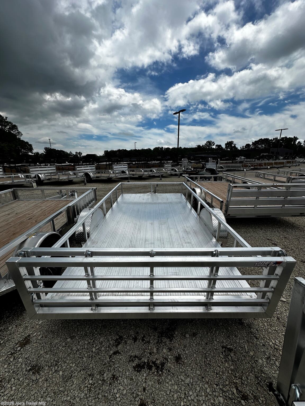 Legend - Tandem Axle: Open Deluxe Aluminum Trailer (5,000 lb GVWR), 3'' x 6'' Extruded Aluminum Triple Tongue Design, ATP Fenders w/ Gussets, Surface Mount LED Lighting, Pressure Treated Decking, Fold-In Radius Gate, Stake Pockets, 2'' x 4'' Tube Rear Gate Supports, Cross Members: 2'' x 3'' Tube 24'' OC, Frame: 2'' x 4'' Perimeter Tube, Jack: 2,000 lb Top-Wind Set Back Jack w/ Foot, Rear Loading: 48'' Fold-In Radius Tube Gate, Sides: 1.5'' x 1.5'' Tube 15'' Tall, Tongue: 3'' x 6'' Extruded Aluminum Triple Tongue, Top Rail: 2'' x 2'' Tube, Axles: 3,500 lb E-Z Lube 4'' Drop Spring 1 Electric Brake & 1 Idler, Tires/Wheels: ST205/75R14 Nitrogen Filled Silver Mod Steel, Floor: Dura Color Radius Edge Deck, 2'' Straight Coupler, Legend 7X14 Aluminum Bi-Fold Trailer, 4" Tube Main Frame, 24" OC Crossmembers, 15" Side Rails, 3.5K Tandem Axle, 2" Coupler, ST205/75R14 Tires, 2K Tongue Jack, Aluminum Flooring, (4) Stake Pockets