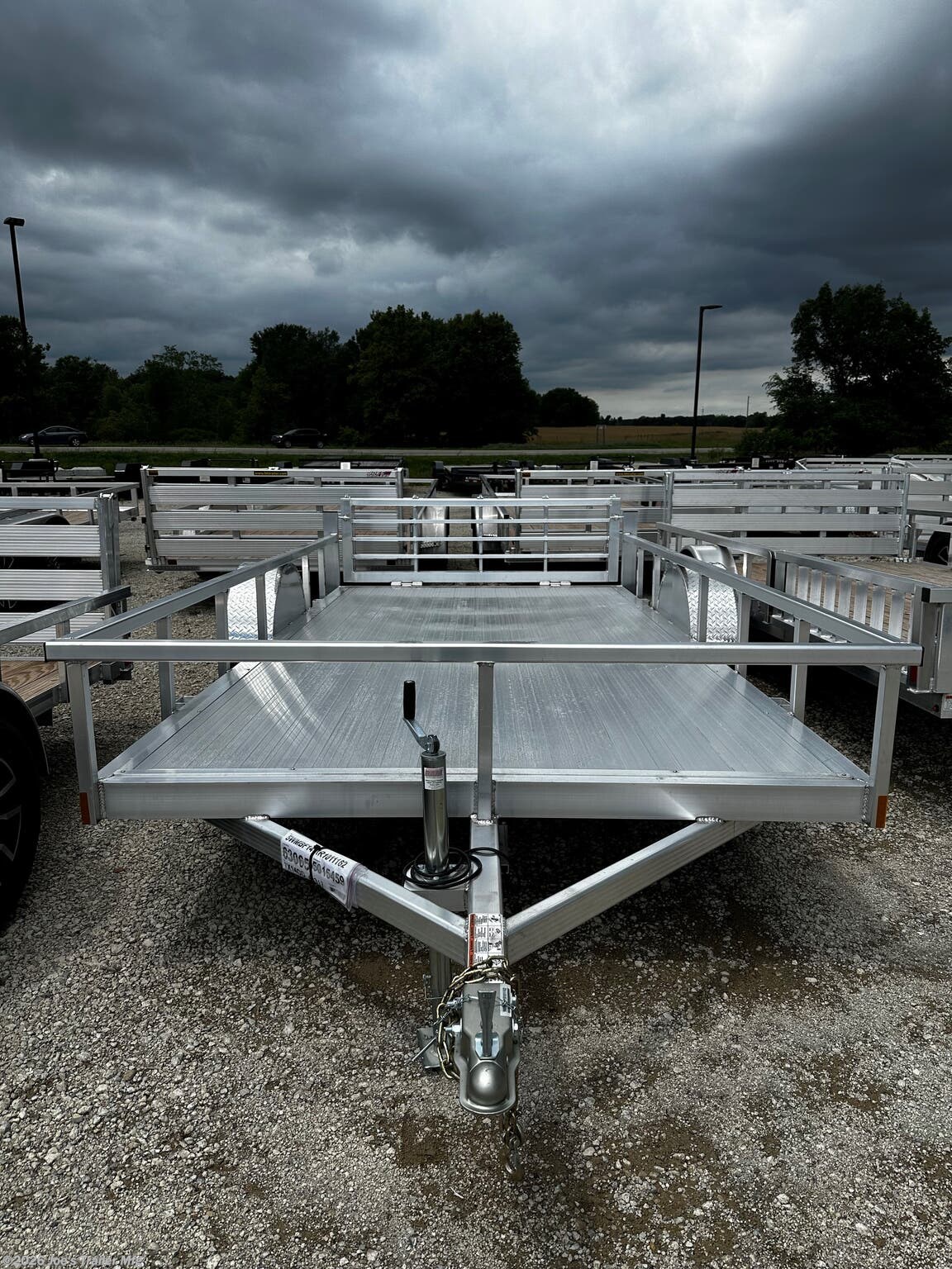 Legend - Tandem Axle: Open Deluxe Aluminum Trailer (5,000 lb GVWR), 3'' x 6'' Extruded Aluminum Triple Tongue Design, ATP Fenders w/ Gussets, Surface Mount LED Lighting, Pressure Treated Decking, Fold-In Radius Gate, Stake Pockets, 2'' x 4'' Tube Rear Gate Supports, Cross Members: 2'' x 3'' Tube 24'' OC, Frame: 2'' x 4'' Perimeter Tube, Jack: 2,000 lb Top-Wind Set Back Jack w/ Foot, Rear Loading: 48'' Fold-In Radius Tube Gate, Sides: 1.5'' x 1.5'' Tube 15'' Tall, Tongue: 3'' x 6'' Extruded Aluminum Triple Tongue, Top Rail: 2'' x 2'' Tube, Axles: 3,500 lb E-Z Lube 4'' Drop Spring 1 Electric Brake & 1 Idler, Tires/Wheels: ST205/75R14 Nitrogen Filled Silver Mod Steel, Floor: Dura Color Radius Edge Deck, 2'' Straight Coupler, Legend 7X14 Aluminum Bi-Fold Trailer, 4" Tube Main Frame, 24" OC Crossmembers, 15" Side Rails, 3.5K Tandem Axle, 2" Coupler, ST205/75R14 Tires, 2K Tongue Jack, Aluminum Flooring, (4) Stake Pockets