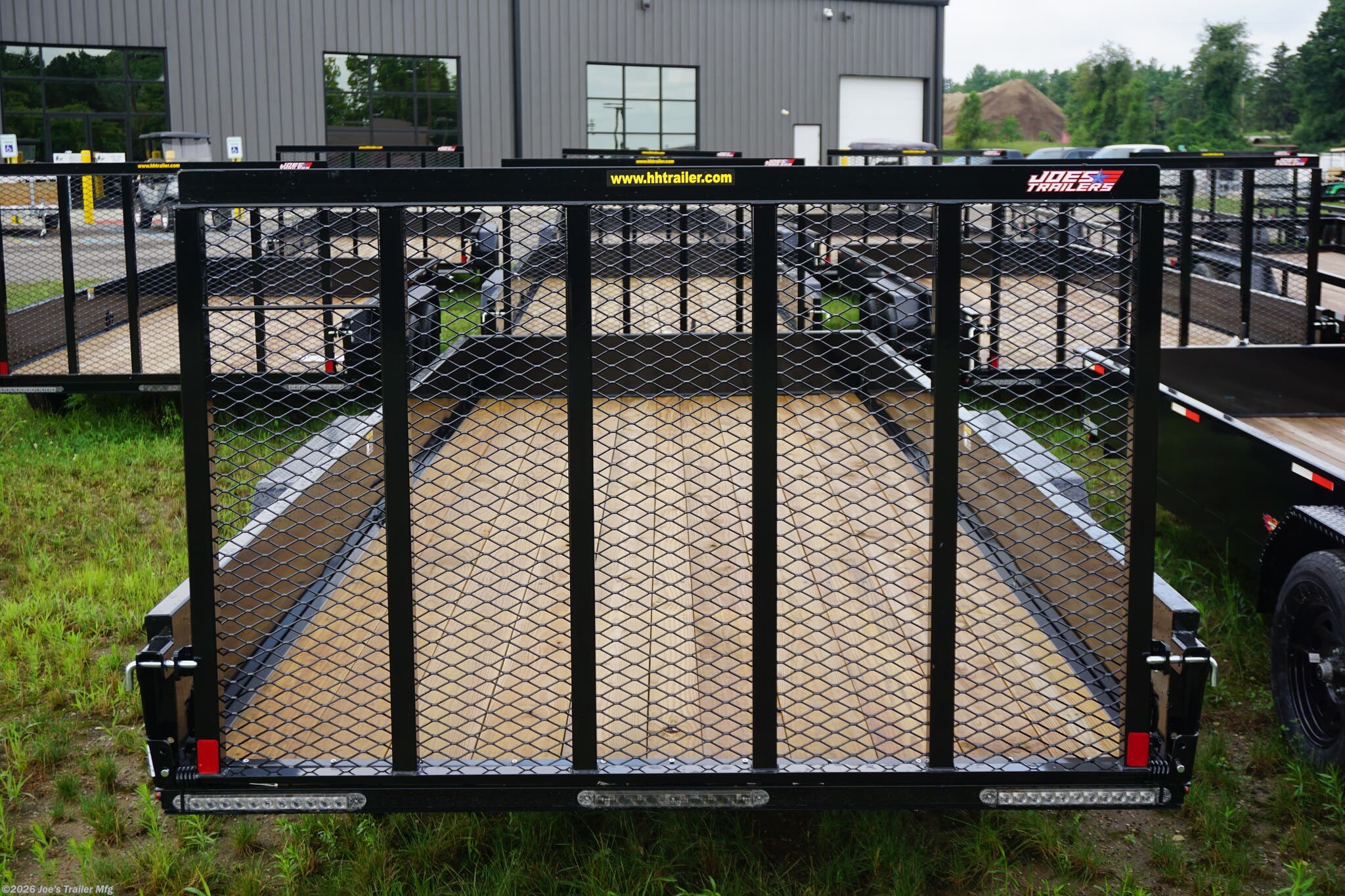 82x18 Tandem Solid Side Trailer, 12-Gauge Steel Frame Trailer, Steel Angle Crossmembers, 12-Gauge Steel Sides, 15" Tall Trailer Sides, 4" Steel Channel Tongue, A-Frame Posi-lock Coupler, Dual Safety Chains and Hooks, 2K Rated Set-Back Jack with Foot, 2x8 Treated Wood Decking, #1 Grade Wood Decking, Welded Front Board Retainer, Rear End Cap Trailer, 50" Spring Assisted Gate, Grab Handle Trailer, Steel Tread Plate Fenders, Spring Suspension Trailer, Easy Lube Hubs, Radial Tires Black Steel Wheels, Enclosed Sealed Wiring Harness, Full LED DOT Compliant Lighting, D-Rings Tie Downs, Spare Tire Mount, Brakes Equipped Trailer, Load Angle 22°, Ramp Length 50", Ramp Pivot Point Measurement.