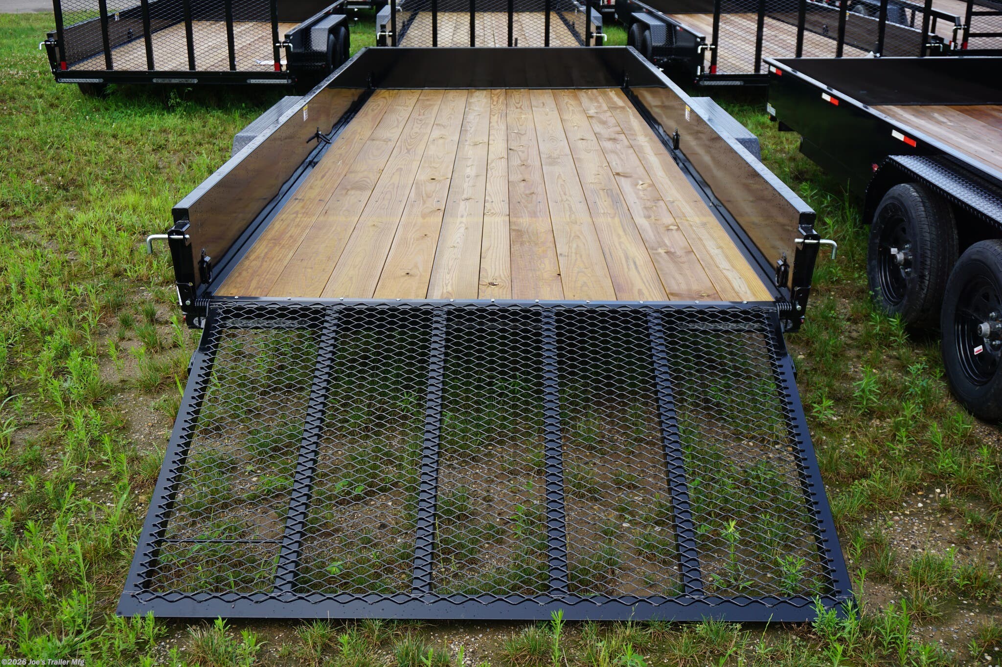 82x18 Tandem Solid Side Trailer, 12-Gauge Steel Frame Trailer, Steel Angle Crossmembers, 12-Gauge Steel Sides, 15" Tall Trailer Sides, 4" Steel Channel Tongue, A-Frame Posi-lock Coupler, Dual Safety Chains and Hooks, 2K Rated Set-Back Jack with Foot, 2x8 Treated Wood Decking, #1 Grade Wood Decking, Welded Front Board Retainer, Rear End Cap Trailer, 50" Spring Assisted Gate, Grab Handle Trailer, Steel Tread Plate Fenders, Spring Suspension Trailer, Easy Lube Hubs, Radial Tires Black Steel Wheels, Enclosed Sealed Wiring Harness, Full LED DOT Compliant Lighting, D-Rings Tie Downs, Spare Tire Mount, Brakes Equipped Trailer, Load Angle 22°, Ramp Length 50", Ramp Pivot Point Measurement.