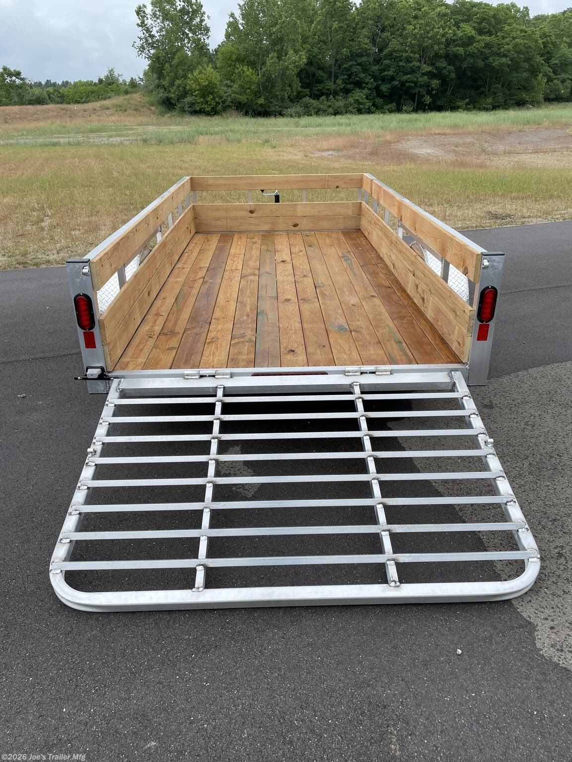 Legend High Side Legend Aluminum 3-Board Utility Trailer, 16" Deck Height, 48" Ramp Gate, 3k EZ-Lube Axle, ST20575R14 Silver Mod Steel Tires, 3" Cross Member, 24" On Center Cross Member, 3" Angle Frame, Treated Wood Decking, LED Lighting, 2" A-Frame Coupler, 2k Top-Wind Jack, ATP Fenders, Load Angle, Ramp Length, 16° Load Angle, 48" Ramp Length, Utility Trailer Features, Aluminum Utility Trailer, Durable Trailer, Heavy-Duty Trailer, Trailer Accessories, Utility Trailer Specifications, EZ-Lube Axle Benefits, ST20575R14 Tires, Steel Mod Tires, Utility Trailer Decking, Wood Decking for Trailers, LED Trailer Lighting, A-Frame Coupler, Trailer Jack, Top-Wind Jack, ATP Fender Design, Ramp Gate Utility Trailer, Trailer Cross Members, Utility Trailer Frame, Loading Ramp for Trailers.