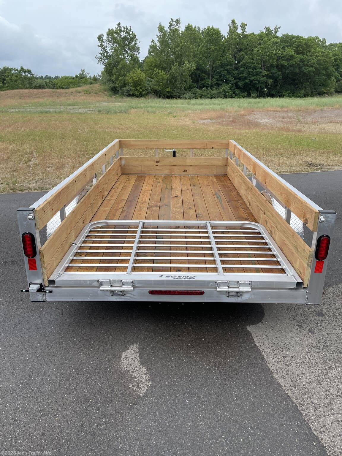 Legend High Side Legend Aluminum 3-Board Utility Trailer, 16" Deck Height, 48" Ramp Gate, 3k EZ-Lube Axle, ST20575R14 Silver Mod Steel Tires, 3" Cross Member, 24" On Center Cross Member, 3" Angle Frame, Treated Wood Decking, LED Lighting, 2" A-Frame Coupler, 2k Top-Wind Jack, ATP Fenders, Brakes: None, Load Angle & Ramp Length, Load Angle: 16°, Ramp Length: 48", Measured from Ramp Pivot Point, Aluminum Utility Trailer, Lightweight Aluminum Trailer, Durable Utility Trailer, Utility Trailer with Ramp Gate, EZ-Lube Axle Utility Trailer, Steel Tires Utility Trailer, Cross Member Utility Trailer, Treated Wood Deck Utility Trailer, LED Lights Trailer, A-Frame Coupler Trailer, Top-Wind Jack Trailer, ATP Fenders Utility Trailer, No Brakes Utility Trailer, Load Angle Utility Trailer, Ramp Length Utility Trailer, Aluminum Utility Trailer Features, Utility Trailer Specifications, Legend Utility Trailer Overview.