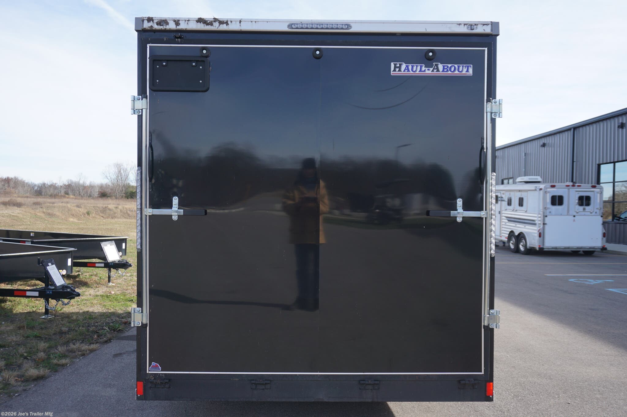 Haul-About 75” x 16’ enclosed trailer, 75” x 16’ trailer, Haul-About aluminum enclosed trailer, dual axle trailer, 2 x 3,500 lb axle trailer, aluminum cargo trailer, bumper pull enclosed trailer, black enclosed trailer, ST205/75R15 trailer tires, 15-inch trailer rims, electric brake trailer, 7,000 lb GVWR trailer, 4,314 lb payload trailer, 2,686 lb curb weight trailer, 75” wide trailer, 16’ long trailer, LED trailer lights, outside LED light with side door switch, 2,000 lb capacity D-rings, recessed floor D-rings, trailer with recessed D-rings, scoop vents trailer, trailer with flush lock, bar lock and flush lock, trailer with flip-up door, UTV trailer, enclosed UTV trailer, trailer for UTV