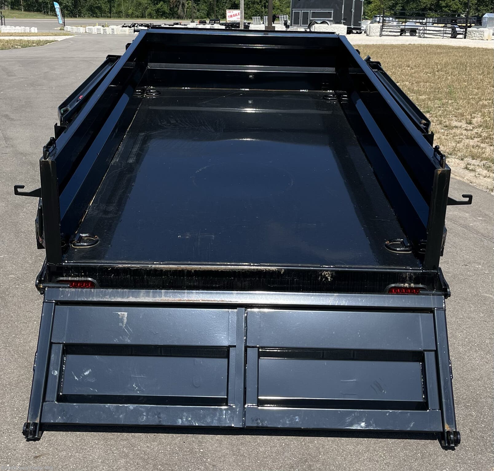 IronBull 5x10 dump trailer, 5x10 dump trailer, 5x10 trailer, IronBull dump trailer, 5x10 dump trailer with 5.2K axles, 2.8 cubic yard dump trailer, dual 6-inch I-Beam frame, 7 gauge steel flooring, heavy-duty steel trailer, 4-inch tubing bed frame, 10 gauge steel sides, 18-inch steel sides, standard retractable tarp kit, 10k drop leg jack, scissor lift dump trailer, adjustable coupler trailer, 2 5/16-inch adjustable coupler, spare tire mount, ramps mounted to side, rear support stand bracket, three-way spreader gate, Powdura powder coat, one cure primer, locking pump box, standard stake pockets, weld-on diamond plate fenders, 5/8-inch D-rings, floor-mounted D-rings, DOT approved LED lighting, lifetime LED lighting, trailer with brakes, equipped brakes, LED voltage indicator, remote control for dump trailer, built-in 5 amp battery charger, heavy-duty dump trailer, small dump trailer, compact dump trailer, versatile dump trailer, farm dump trailer, landscaping dump trailer, construction