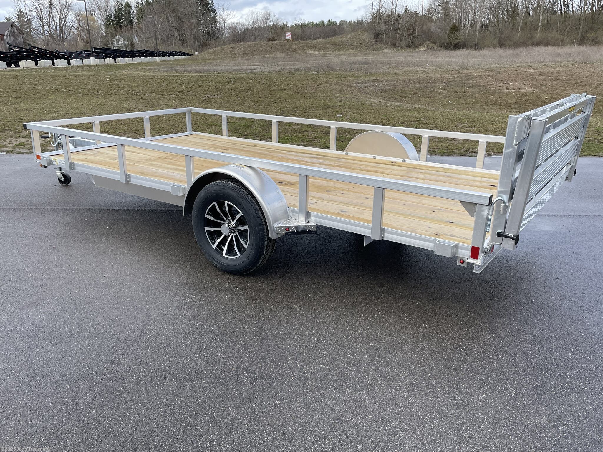 Utility Trailer H & H 7 X 14 Aluminum Rail Side, 3 X 2 Angle Aluminum Extrusion Frame, Aluminum Extrusion Tube Upright Sides, 2 x 2 Tube Top Rail, Aluminum Triple Tube Tongue, Treated Wood Deck, 15" Aluminum Wheels, 15" Radial Tires, A-Frame Posi-lock Coupler, Dual Safety Chains & Hooks, Swivel Jack with Caster Wheel, LED Lighting, Sealed Wiring Harness, Aluminum Stake Pockets, 54" Bi-Fold Gate, Brakes: None, Load Angle & Ramp Length, Load Angle: 17°, Ramp Length: 58", Ramp Pivot Point Measurements, Aluminum Trailer Accessories, Heavy Duty Aluminum Trailer, Aluminum Extrusion Components, Trailer Parts and Accessories, Custom Aluminum Trailer Features, Durable Aluminum Trailer, LED Trailer Lighting, Swivel Jack Trailer Equipment, Safety Chains and Hooks, Aluminum Stake Pocket Design, Treated Wood Decking for Trailers, 15" Radial Trailer Tires, A-Frame Coupler Trailer, Bi-Fold Gate Trailer, High-Quality Aluminum Wheels, Ramp Length Specifications, Trailer Load Angle, Aluminum Extrusion T